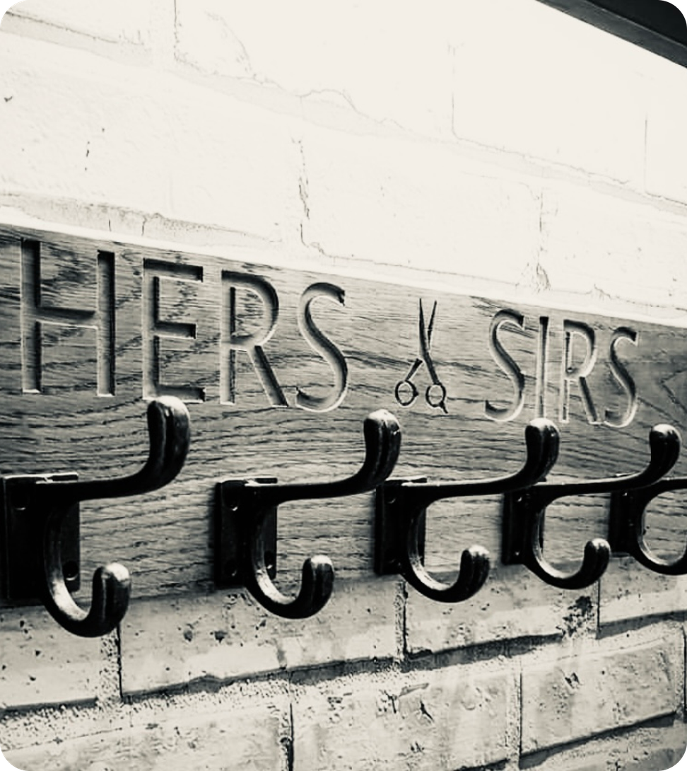 A rustic wooden board with the engraved text