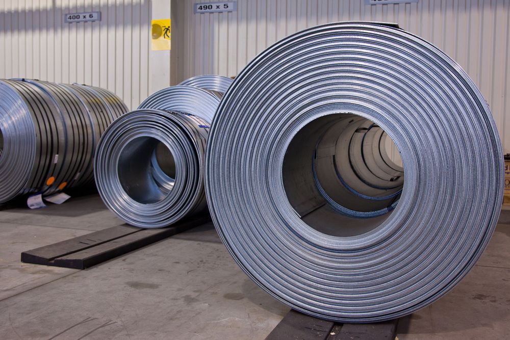 Several Rolls of Metal Are Stacked on Top of Each Other in A Warehouse — Betts Welding Pty Ltd In Moss Vale, NSW
