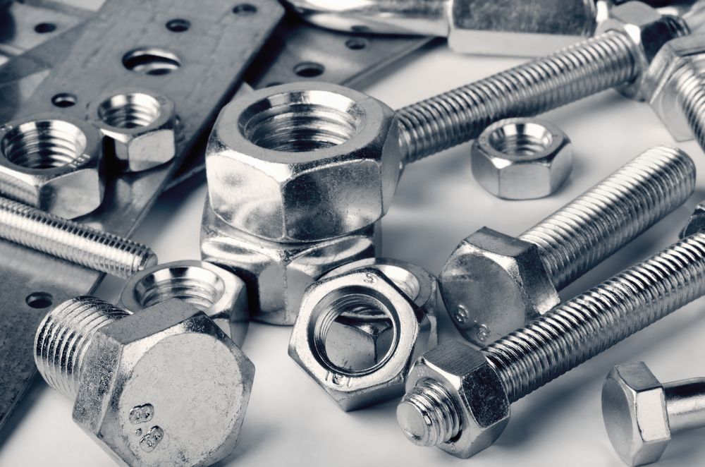 A Bunch of Nuts and Bolts on A Table — Betts Welding Pty Ltd In Moss Vale, NSW