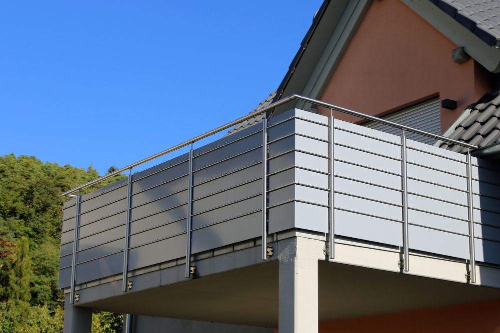 A Balcony with A Metal Railing on The Side of A House — Betts Welding Pty Ltd In Moss Vale, NSW