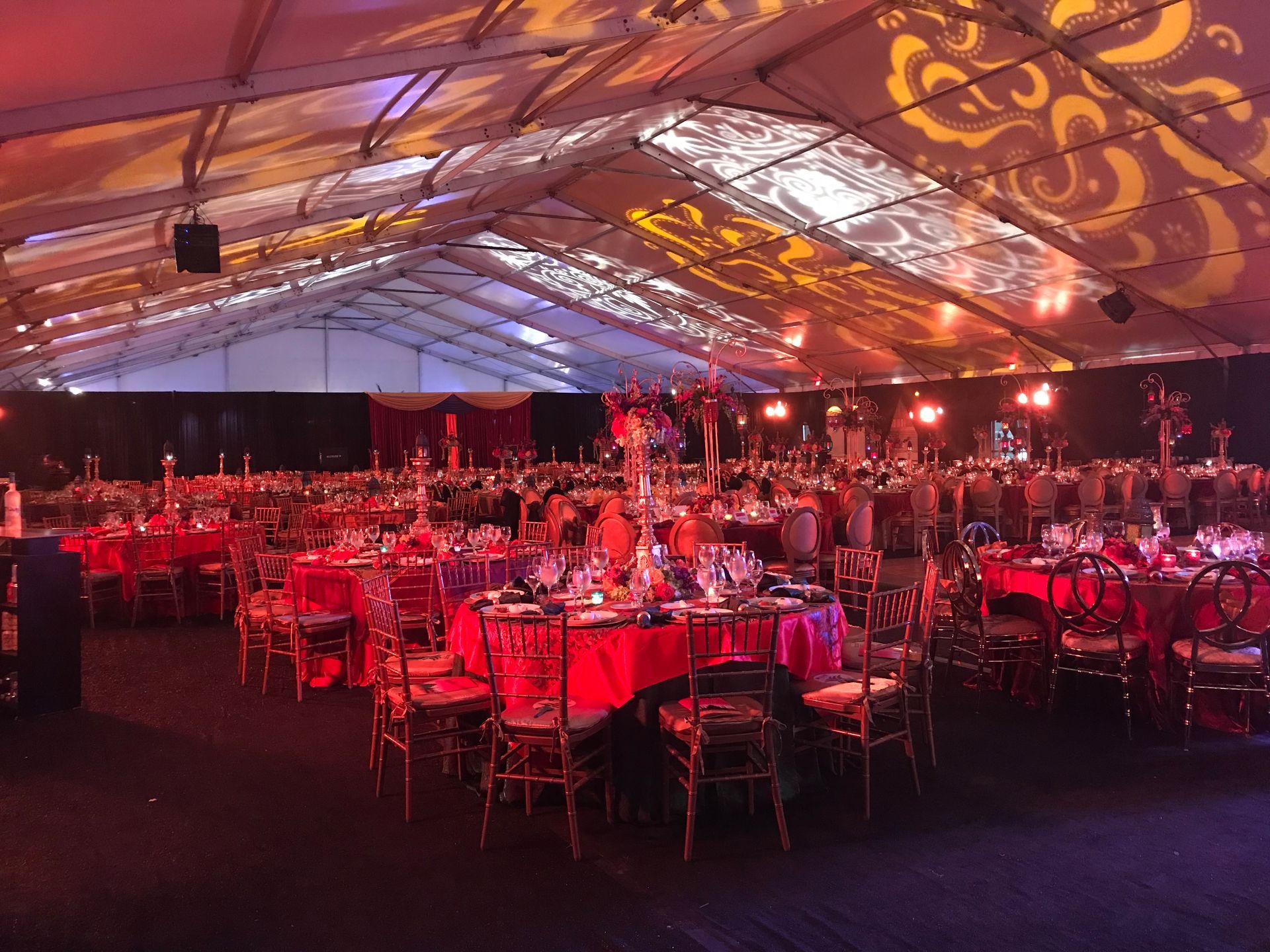 A large tent with tables and chairs set up for a party.