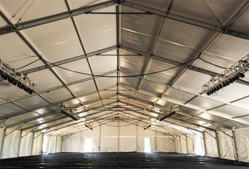 A large empty building with a lot of lights on the ceiling.