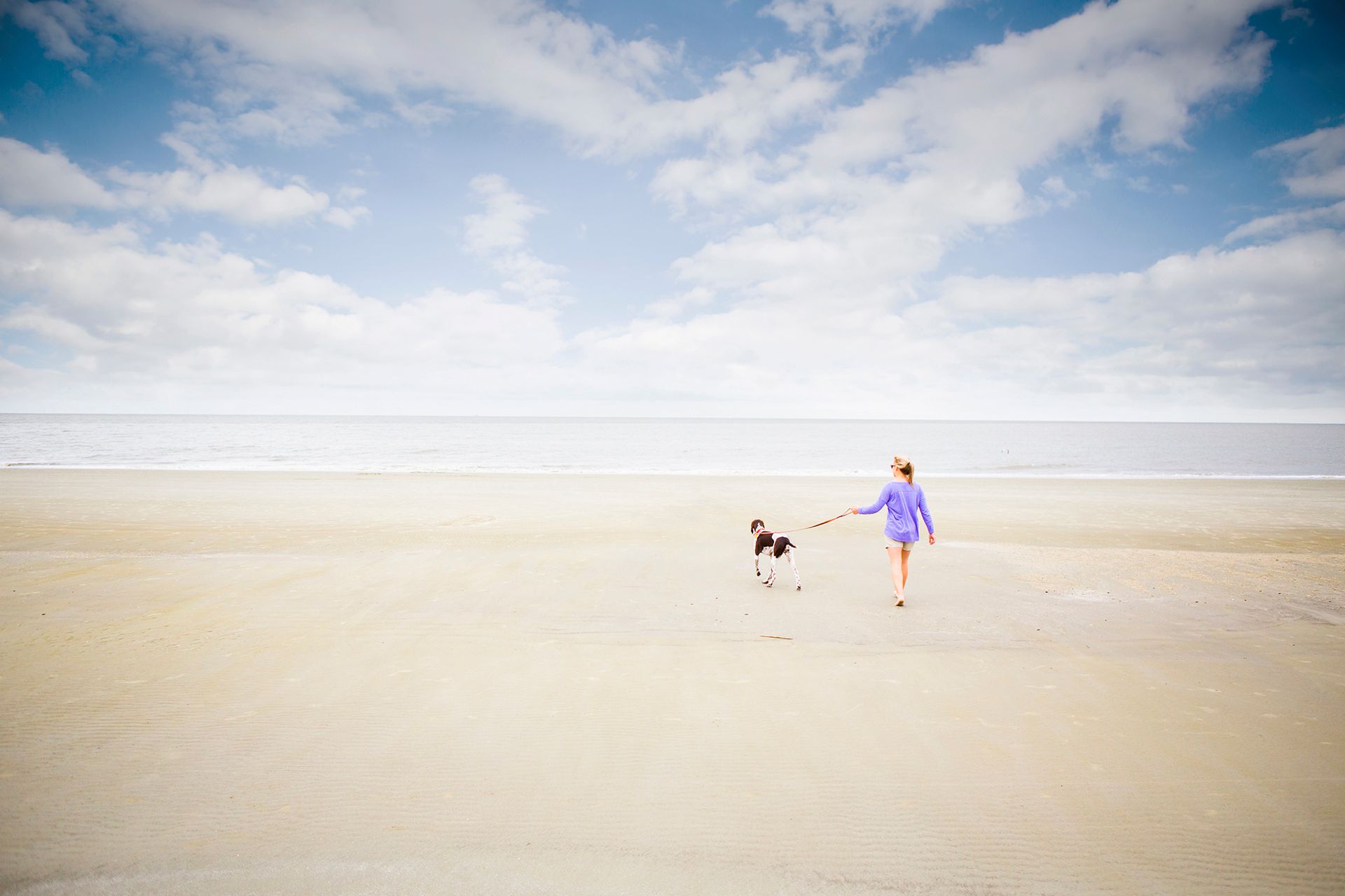 person walking down on beach in Jekyll Island