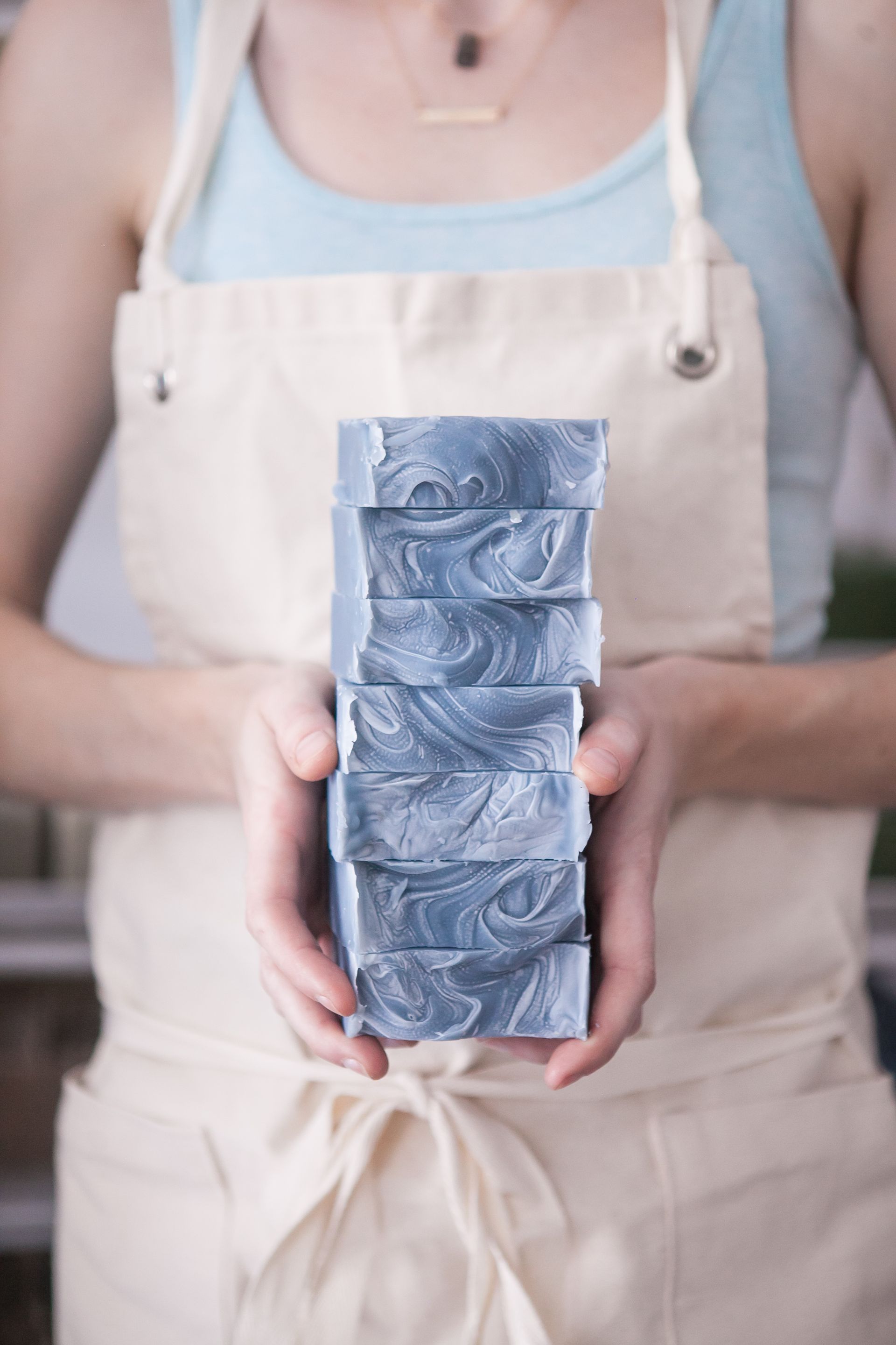 A woman holding a stack of soap