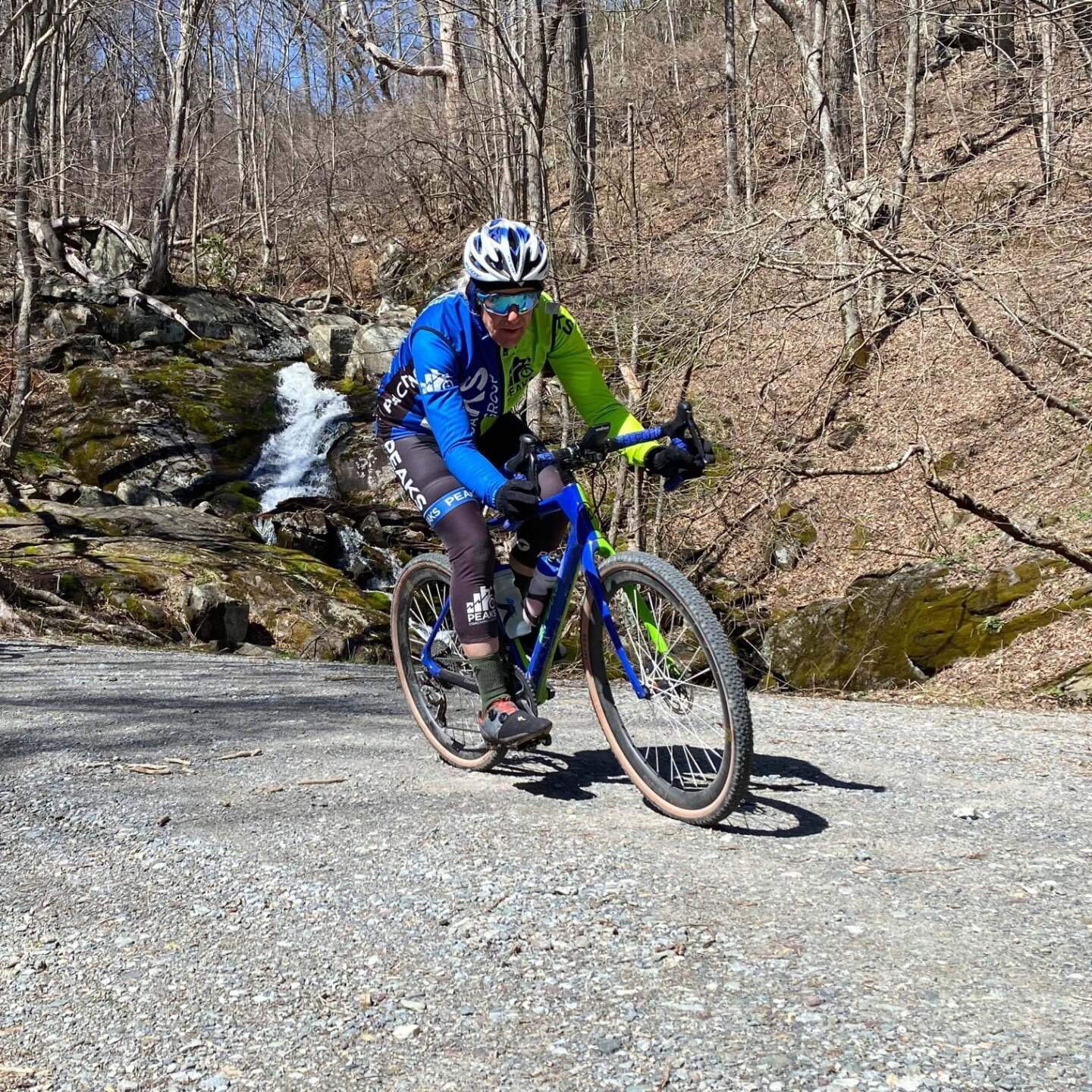 A man is riding a bike down a dirt road.