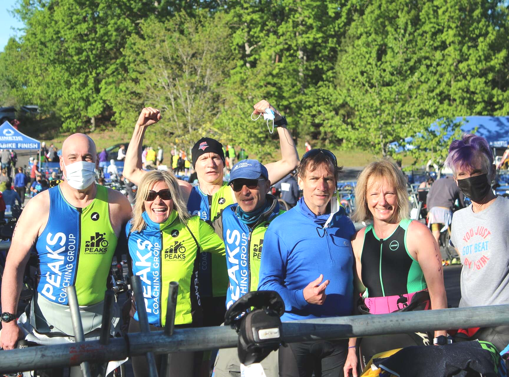 A group of people wearing shirts that say peaks are posing for a picture
