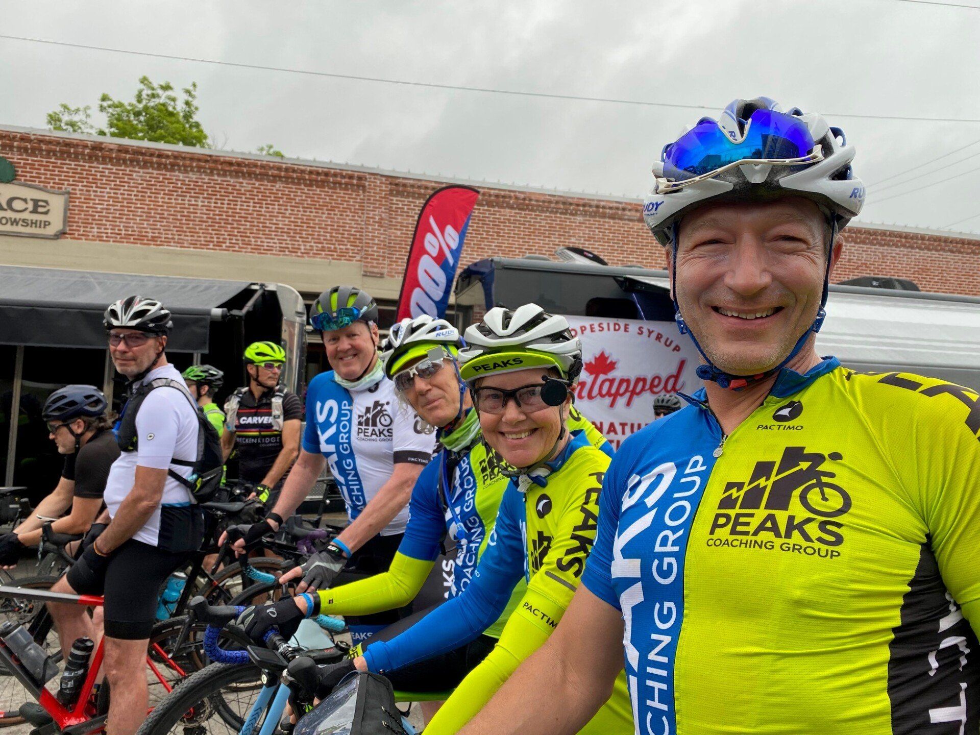 A group of people are standing next to each other on bicycles.
