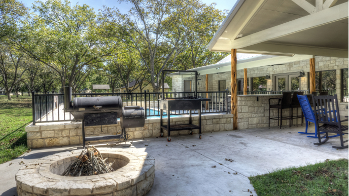 There is a fire pit in the middle of the patio.