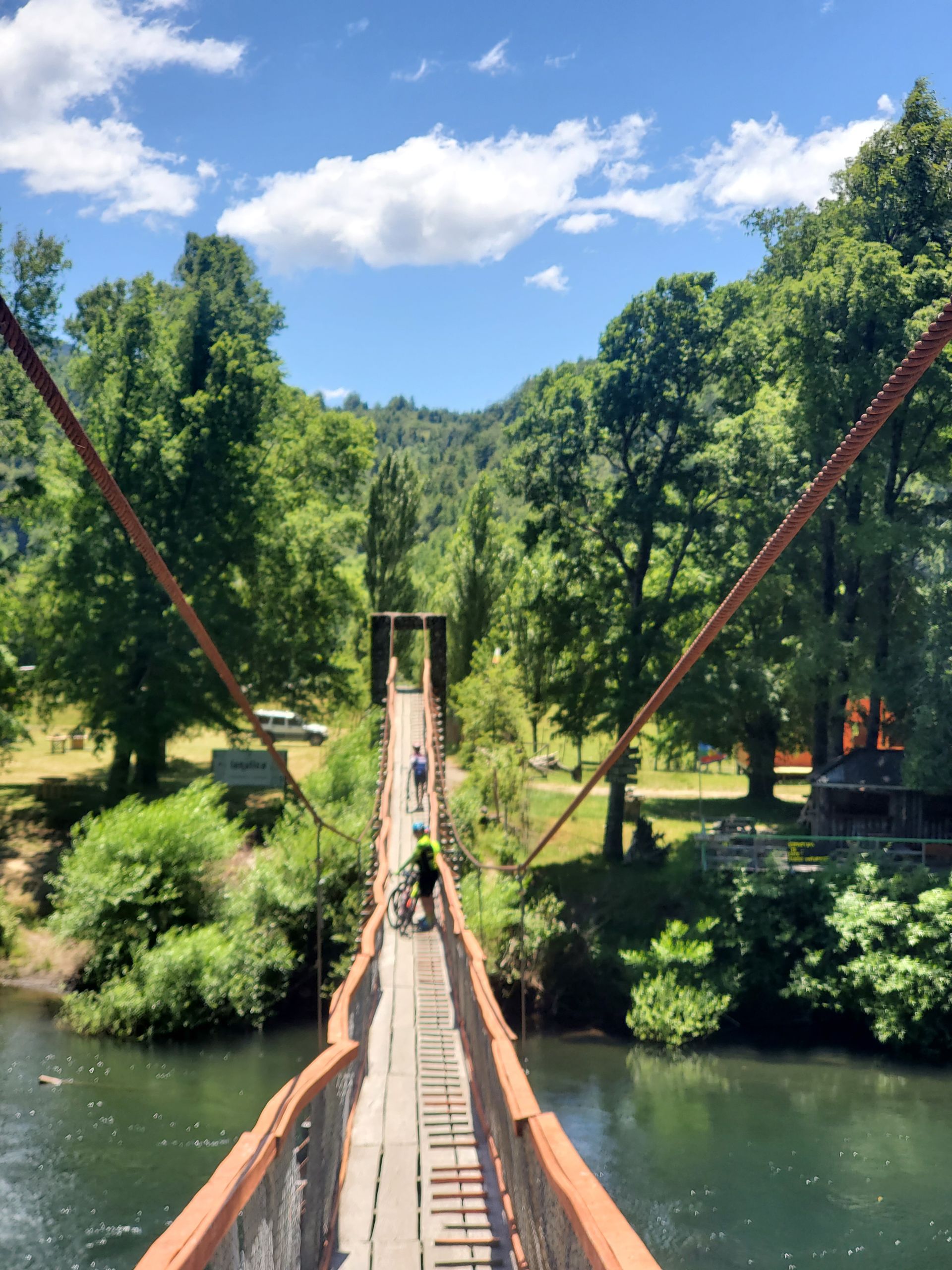 A bridge over a river with trees in the background