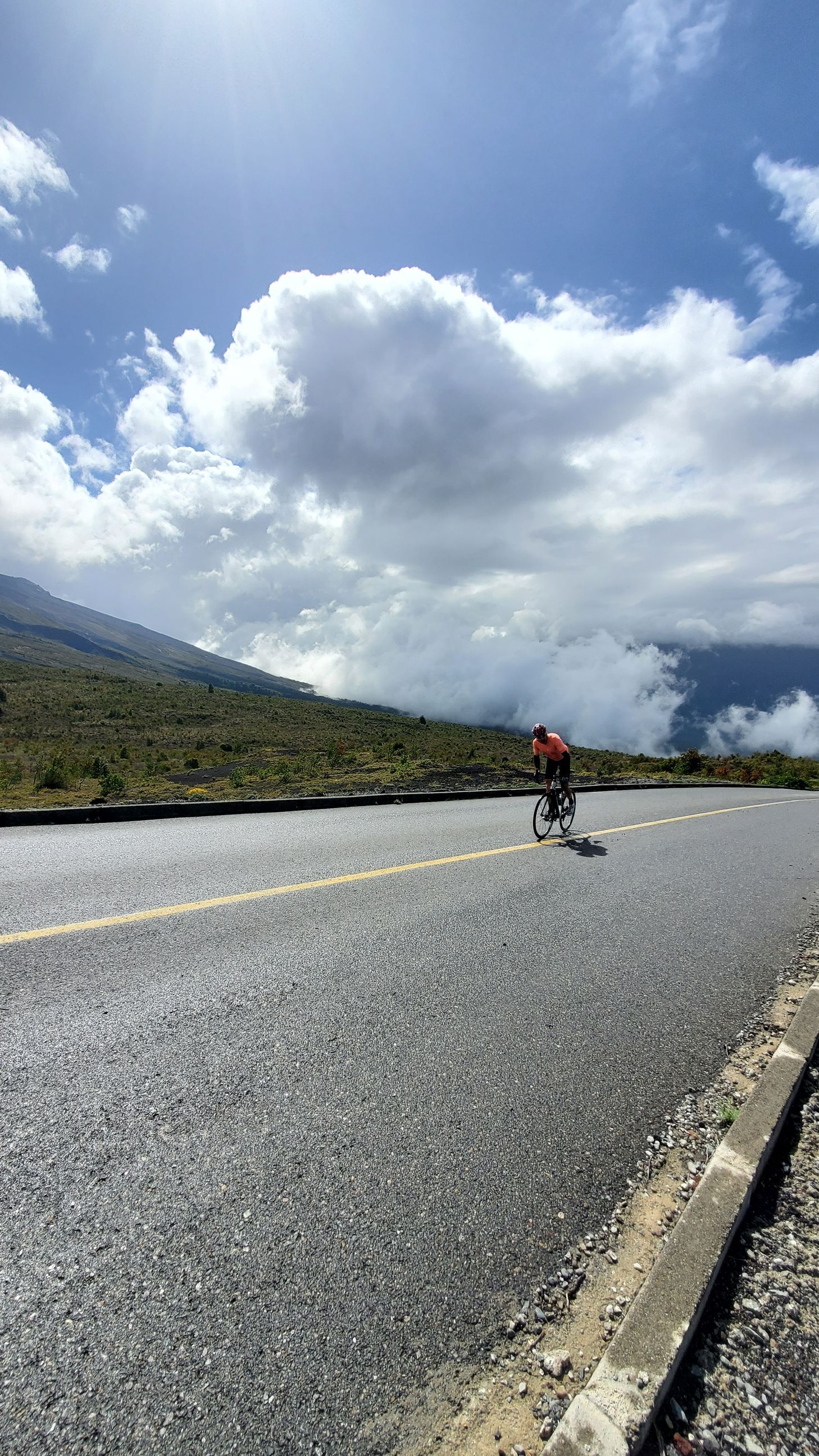 A person is riding a bike down a road.