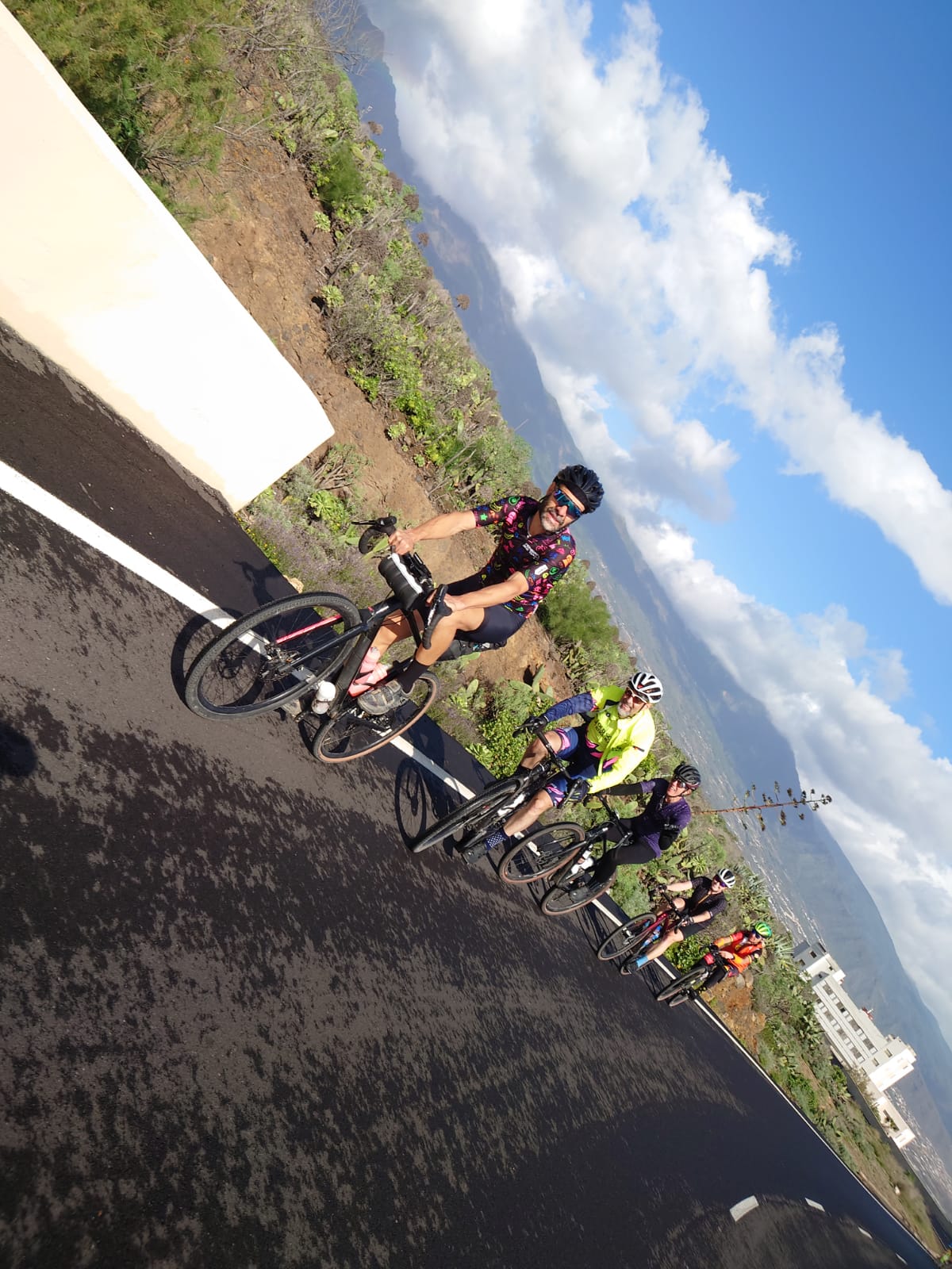 A group of people are riding bicycles down a road.