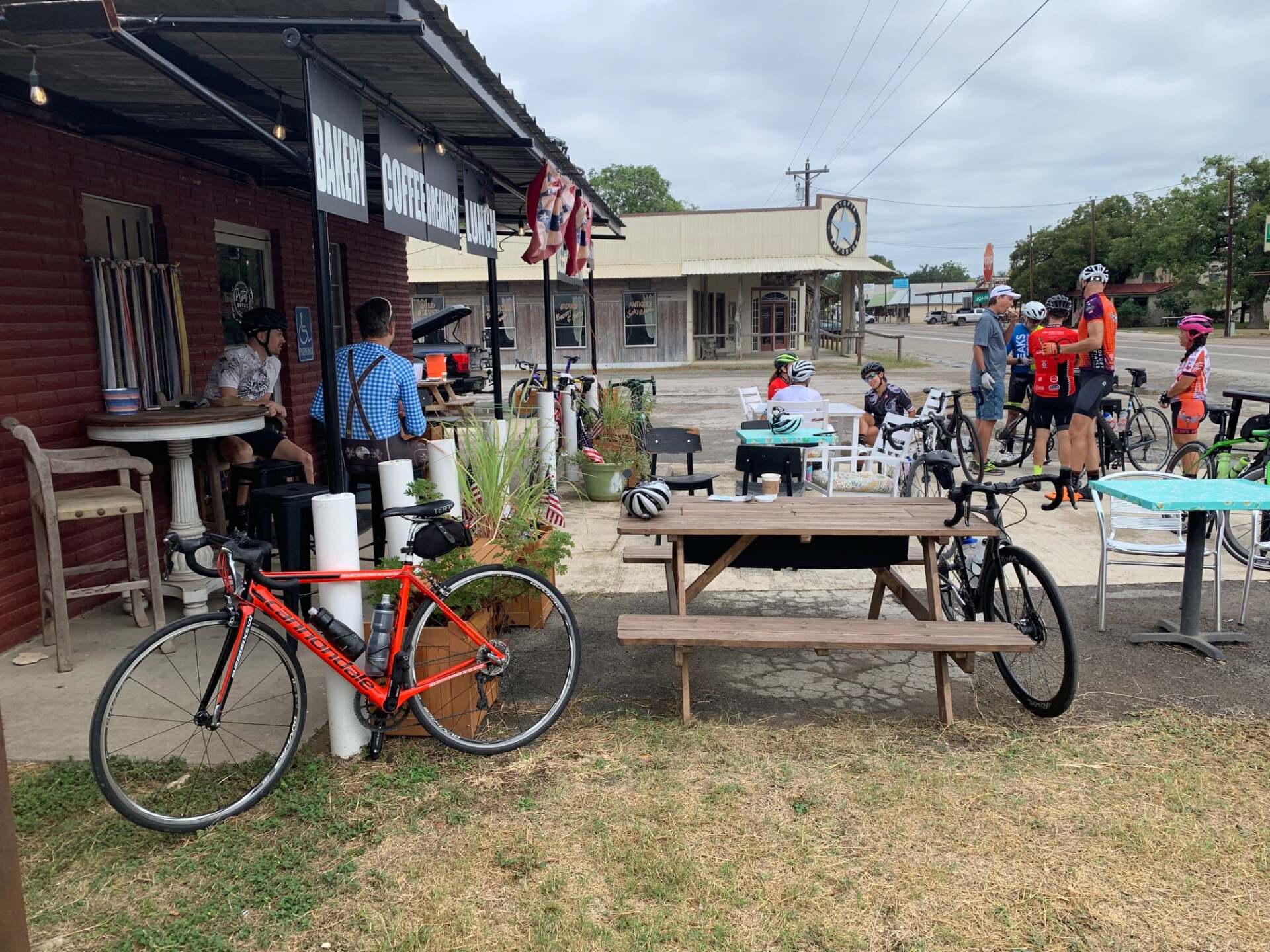 A bicycle is parked in front of a picnic table.