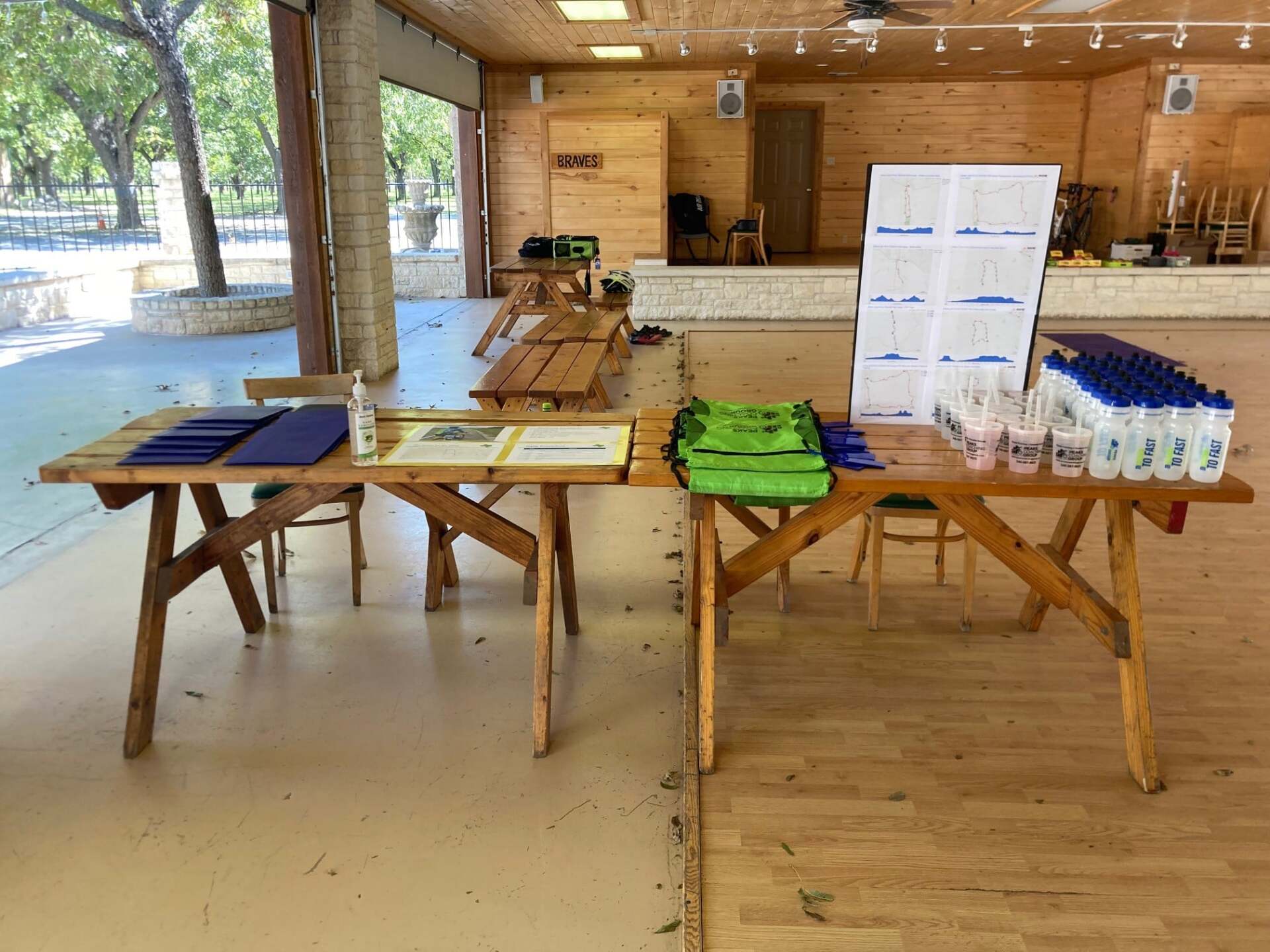 A wooden table with a lot of items on it in a room.