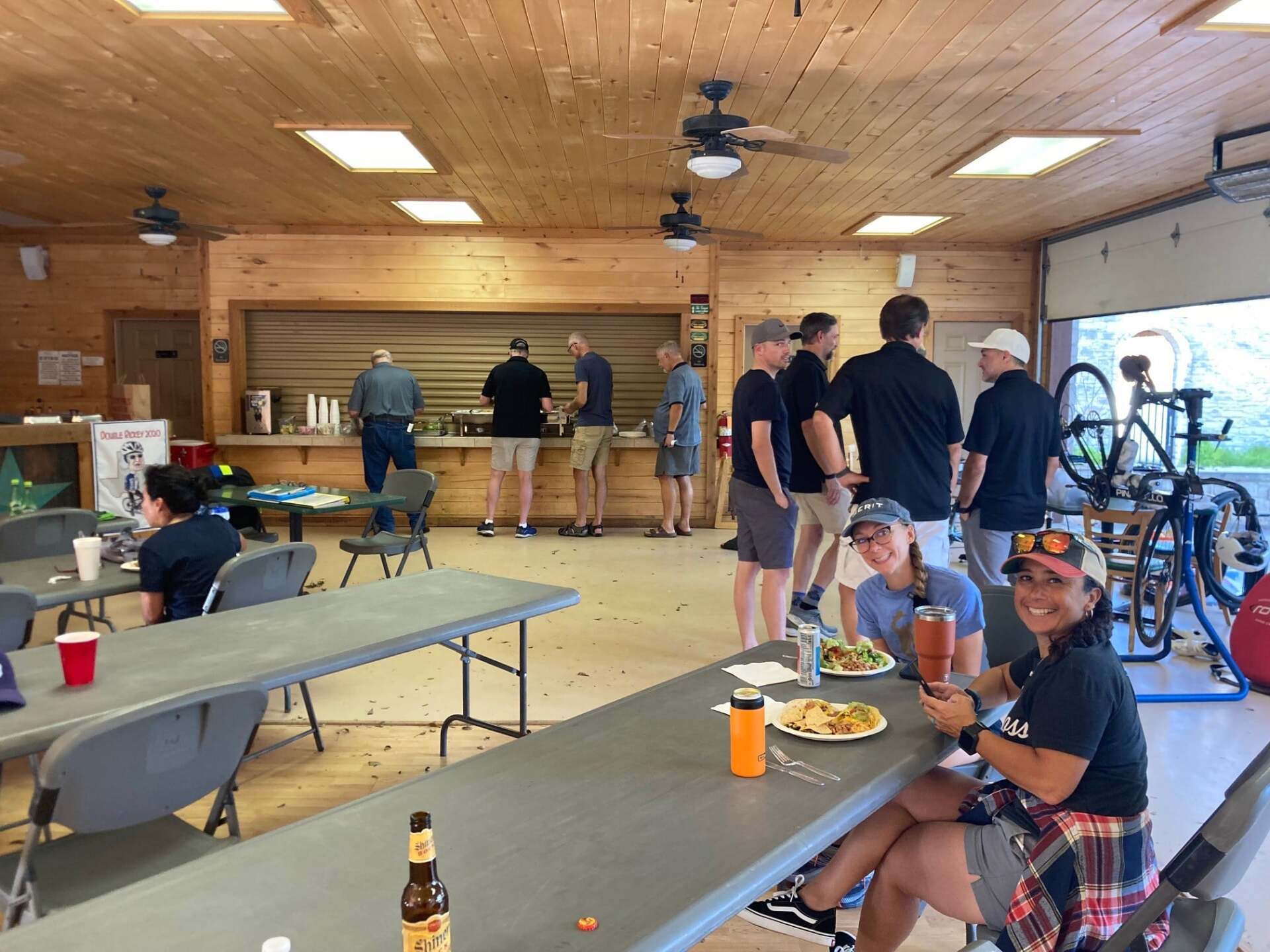A group of people are sitting at tables in a room.