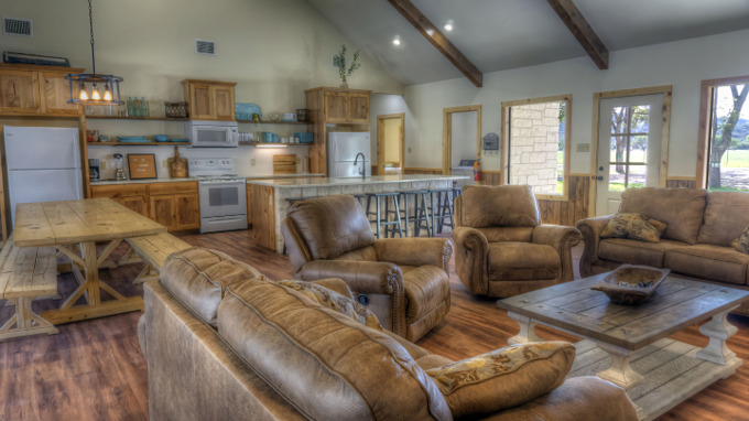 A living room filled with furniture and a kitchen.