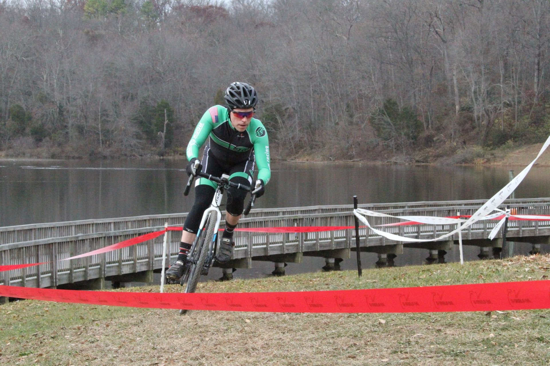 A person is riding a bike on a dirt road.