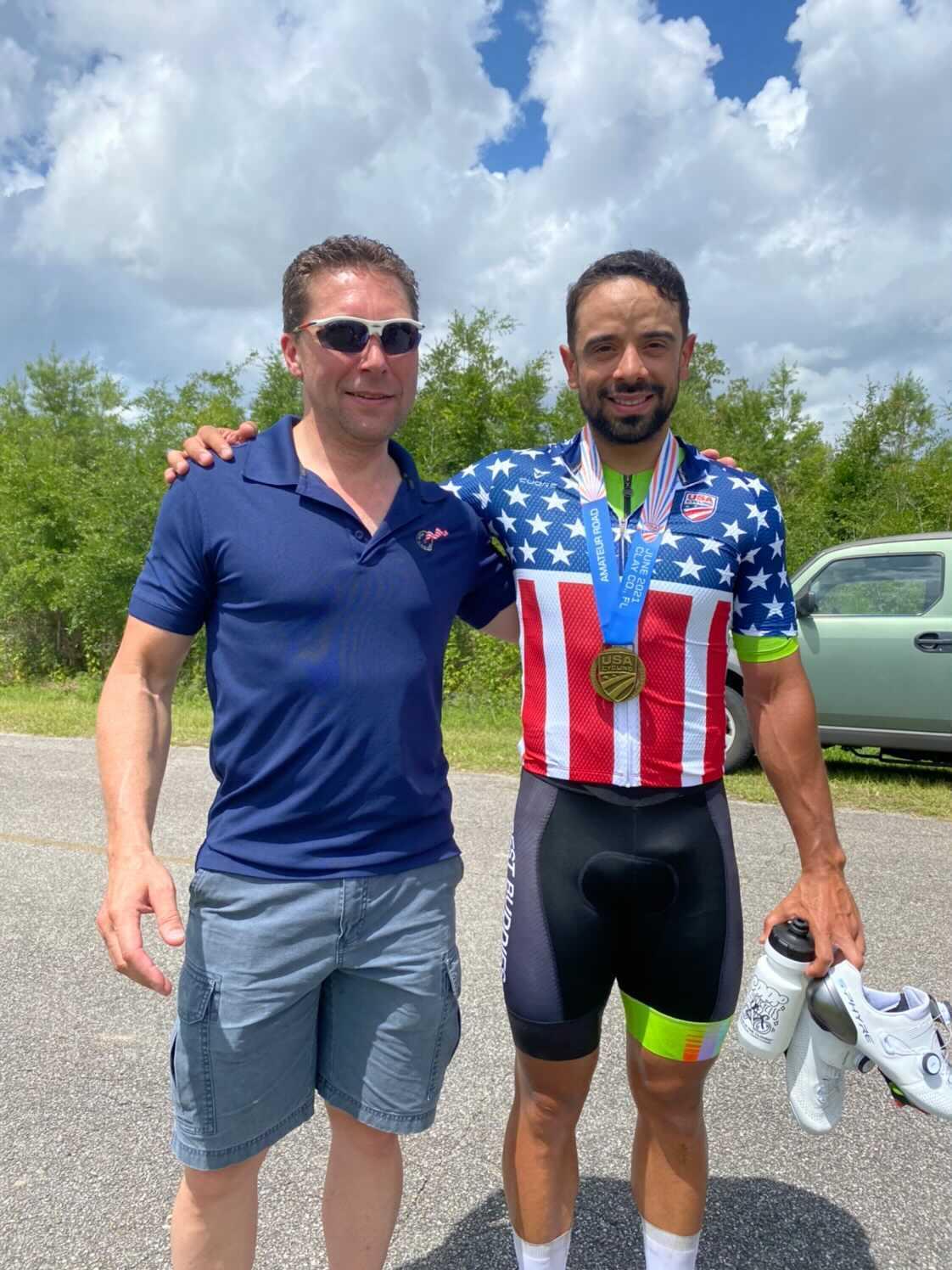 Two men standing next to each other one wearing an american flag shirt