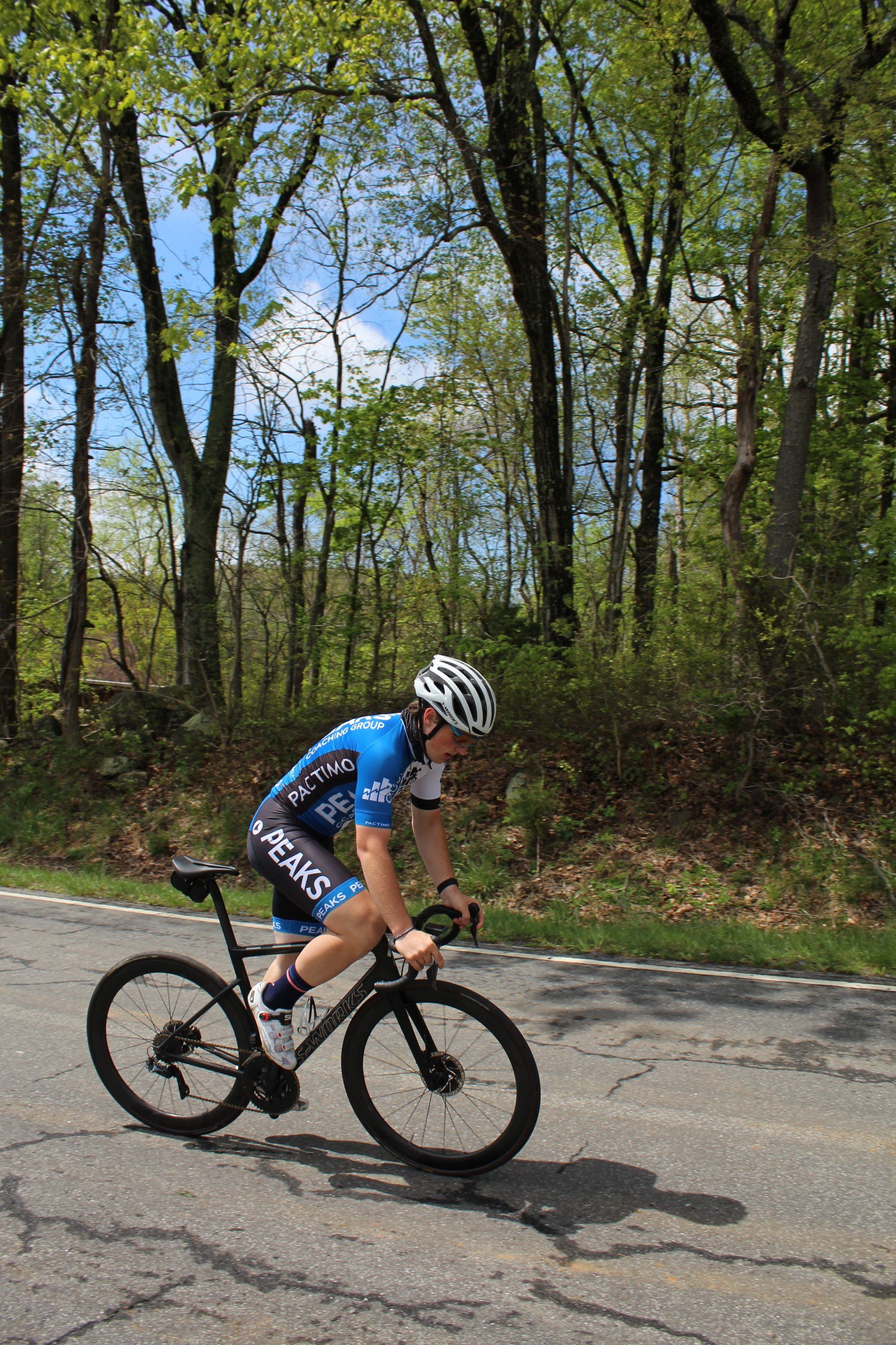A man is riding a bike down a road.