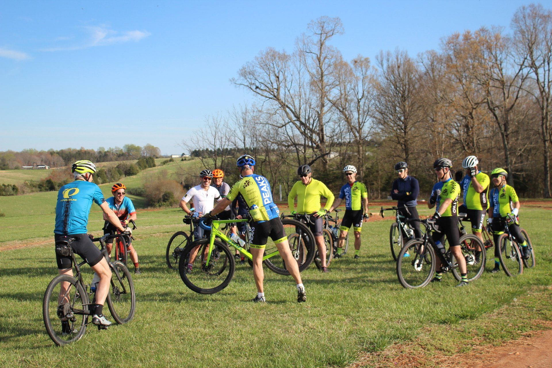 A group of people are riding bicycles in a field.