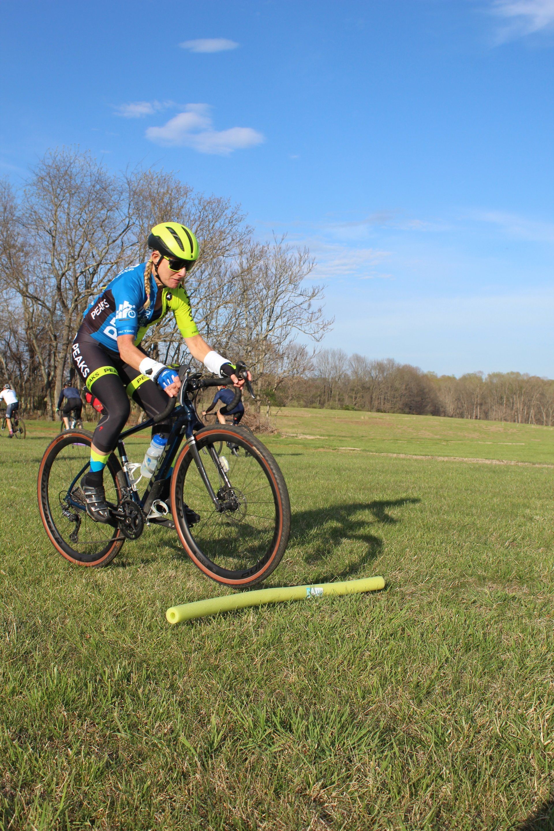A man is riding a bike on a grassy field.
