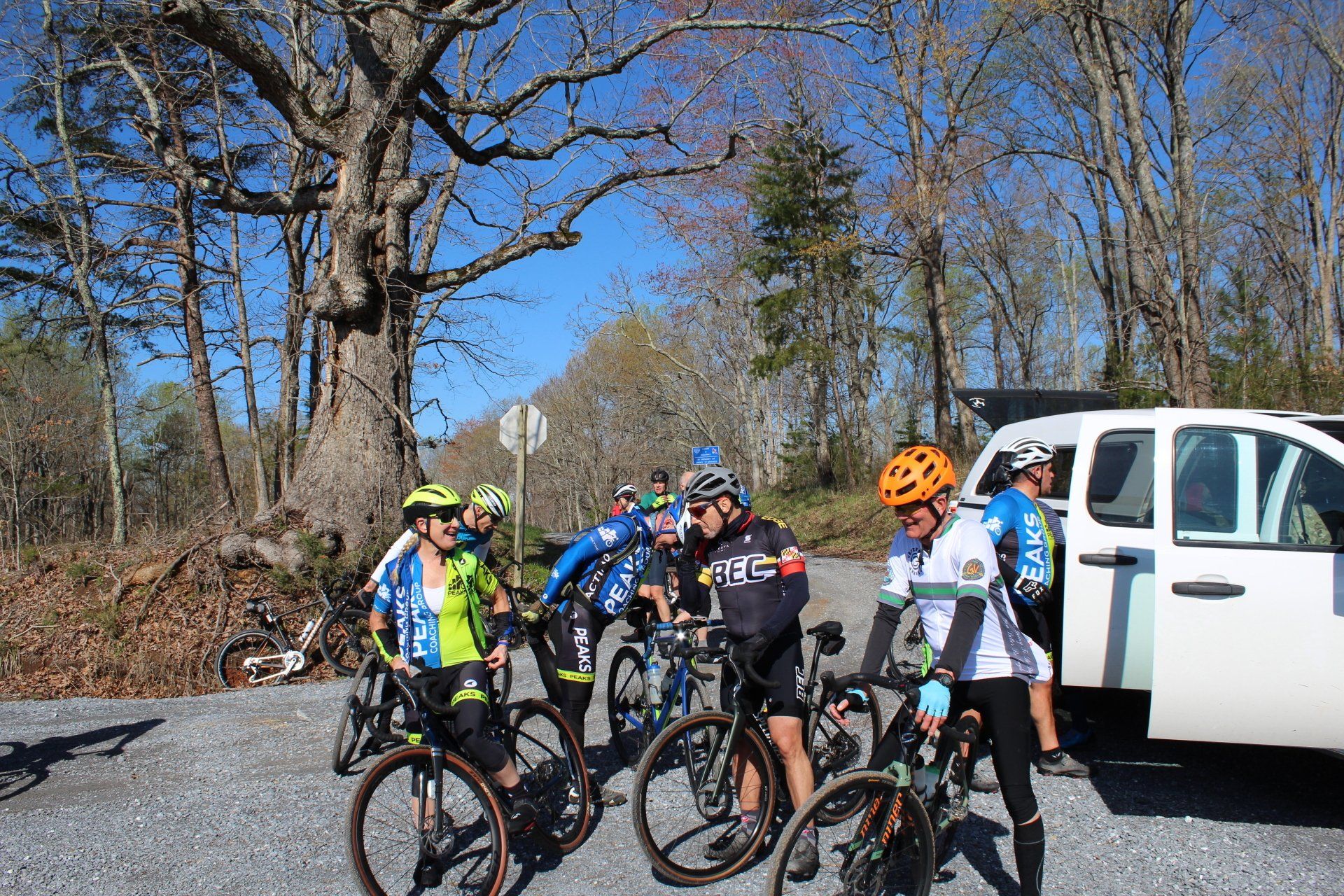 A group of people are standing next to each other on their bikes.