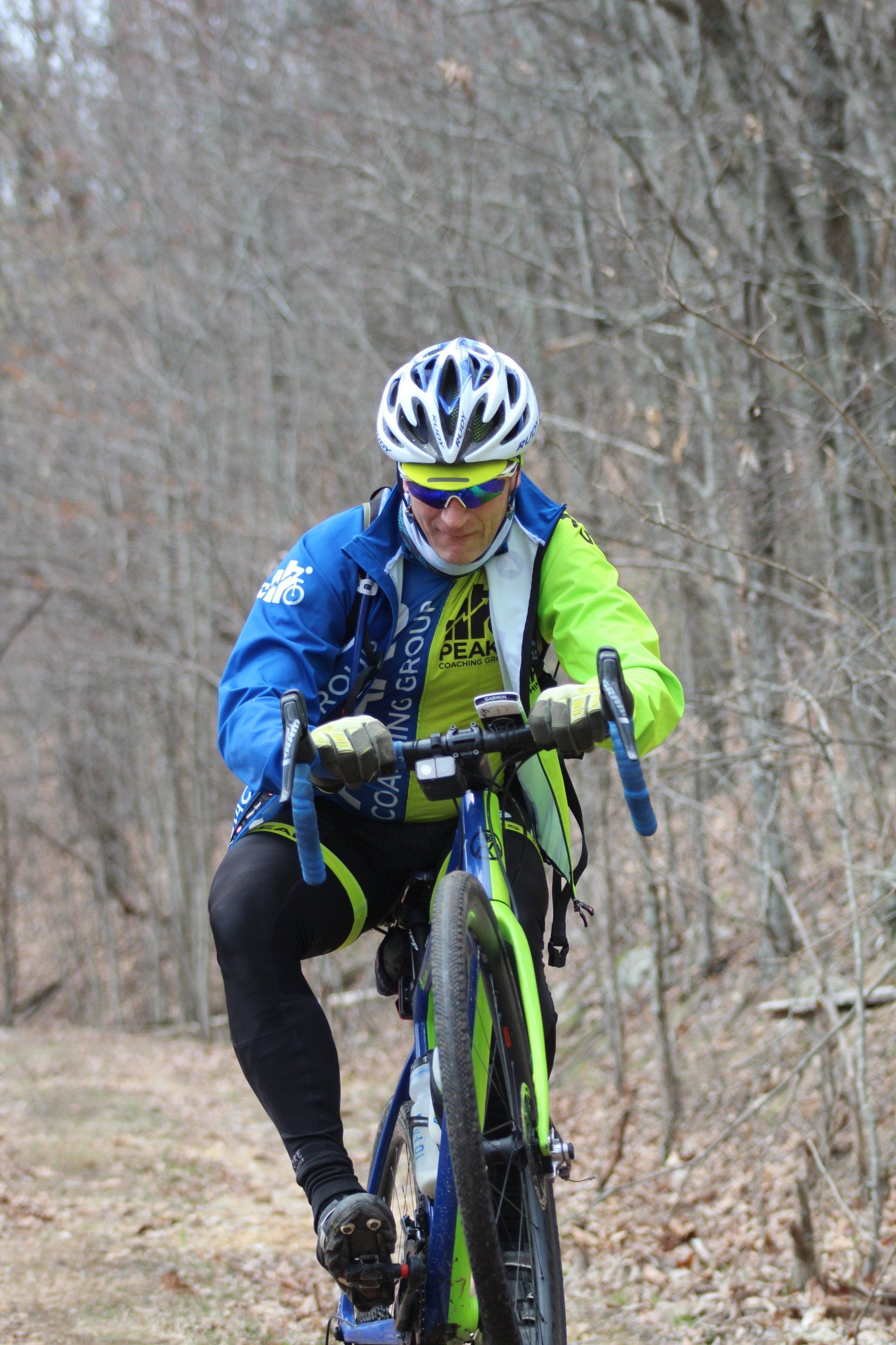 A man is riding a bike on a trail in the woods.