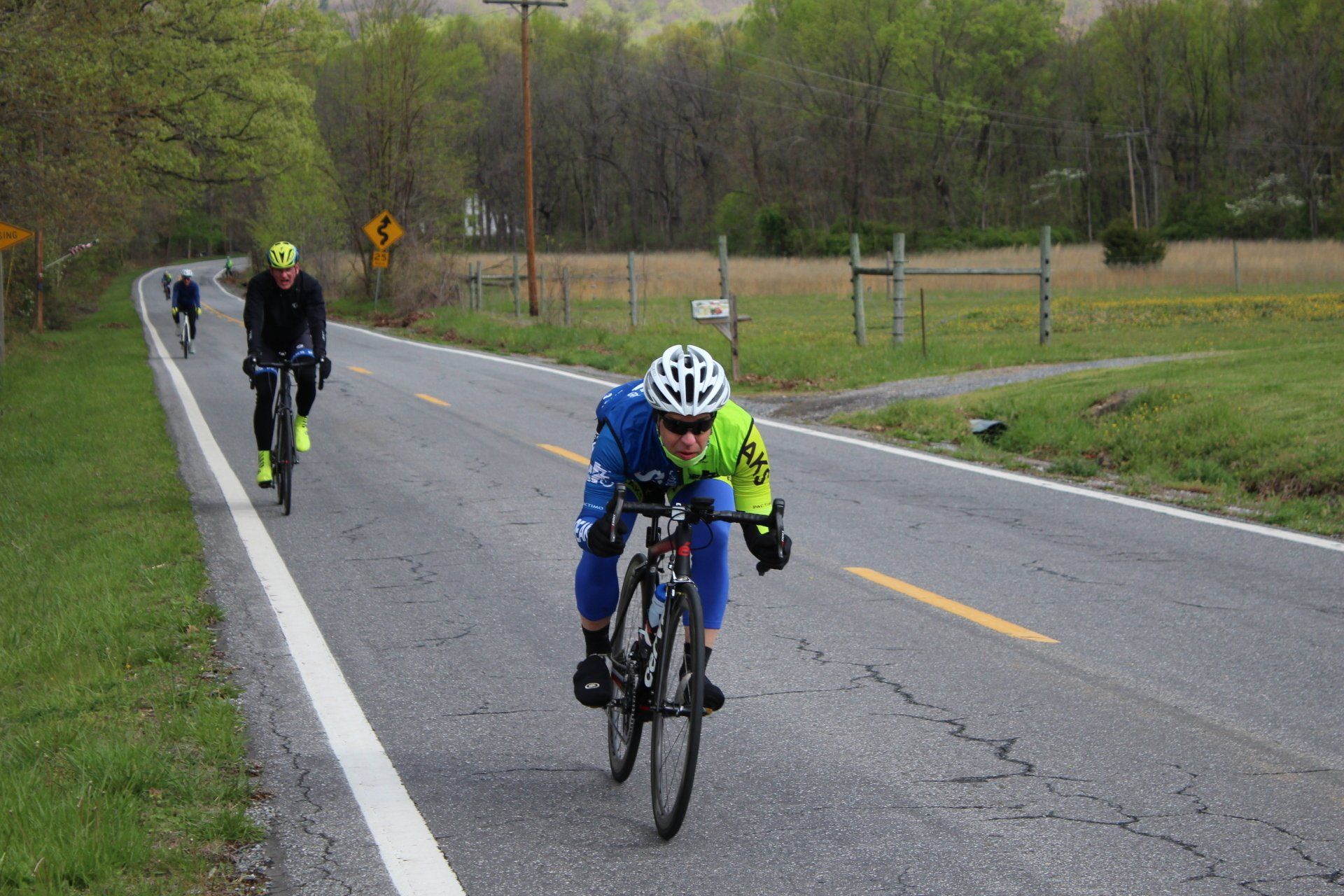 A group of people are riding bicycles down a road.