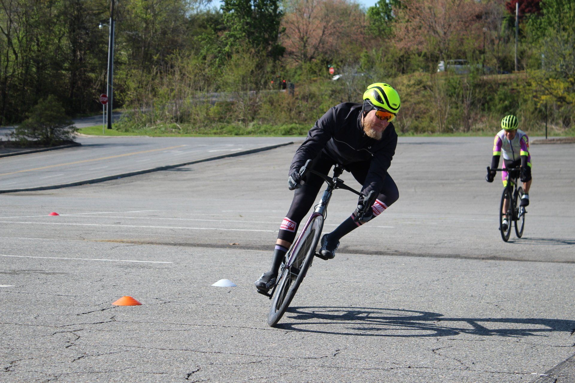 A man is doing a trick on a bike in a parking lot.