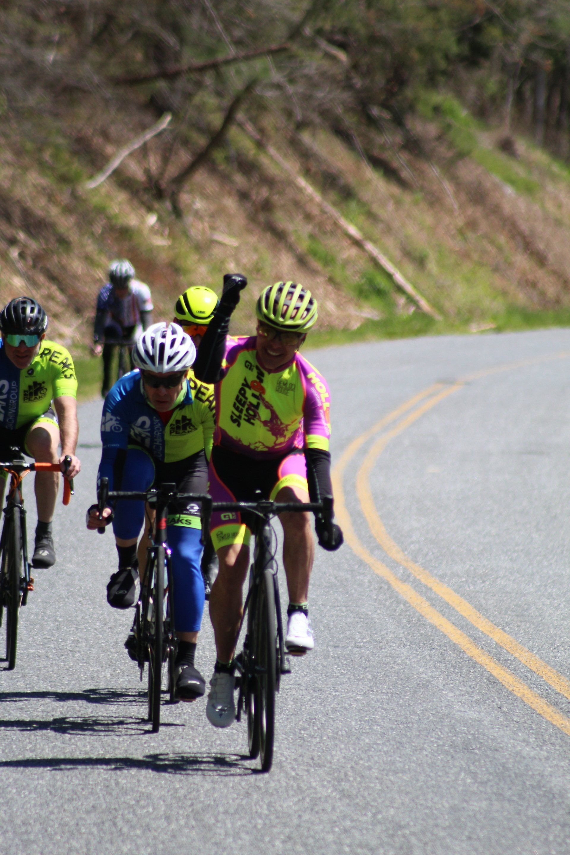 A group of people are riding bicycles down a road.