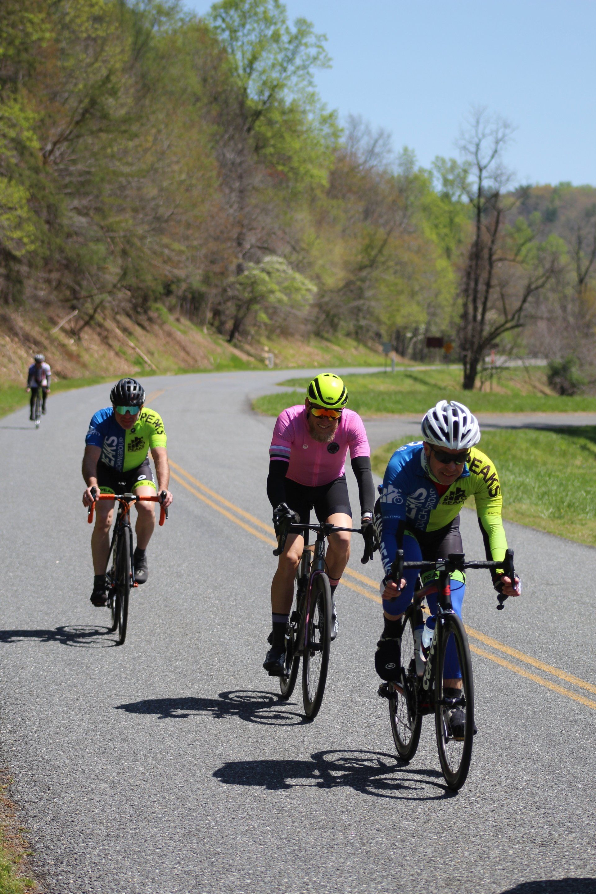 A group of people are riding bicycles down a road.