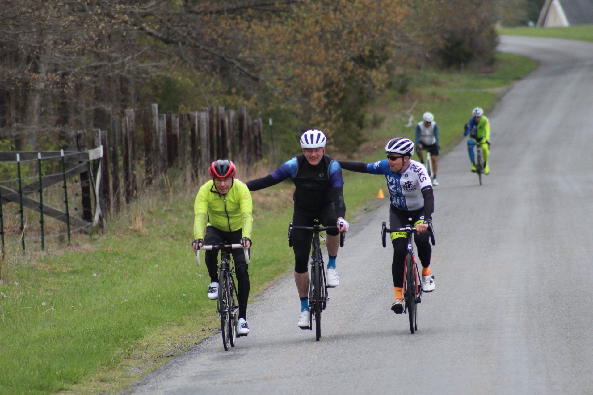 A group of people are riding bicycles down a road.
