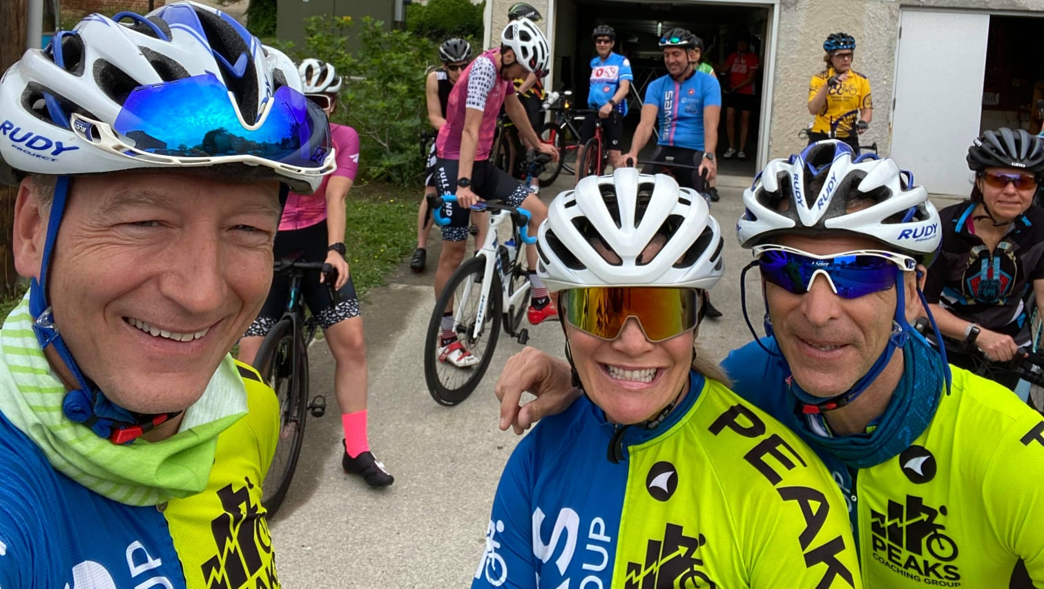 A group of people are standing next to each other wearing helmets and sunglasses.