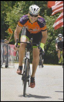 A man riding a bike with the number 87 on his jersey
