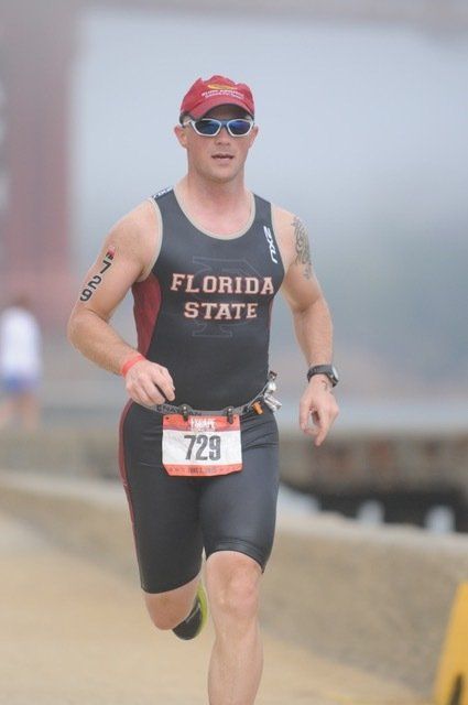 A man in a florida state shirt is running