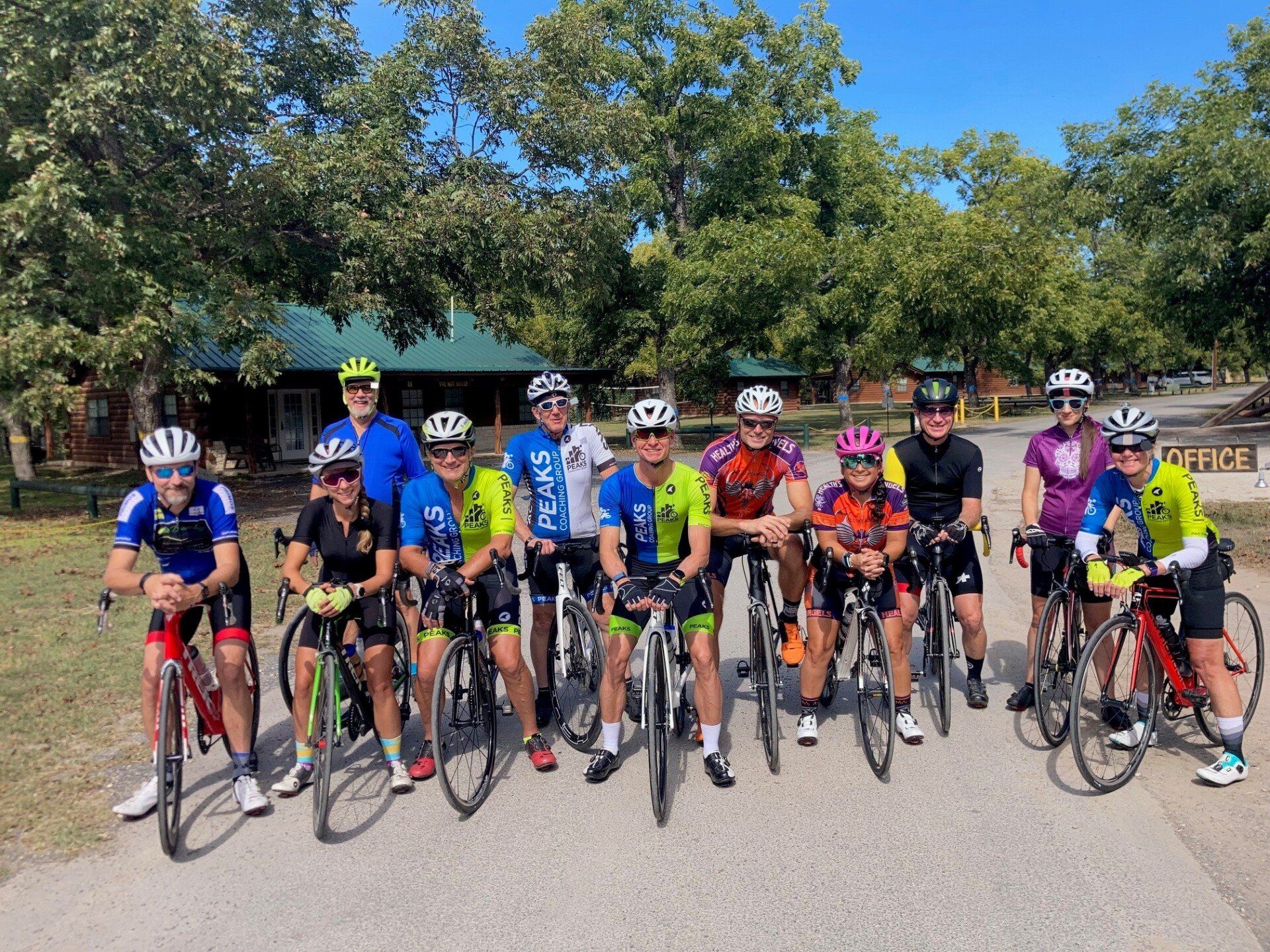 A group of people are standing next to each other on bicycles.