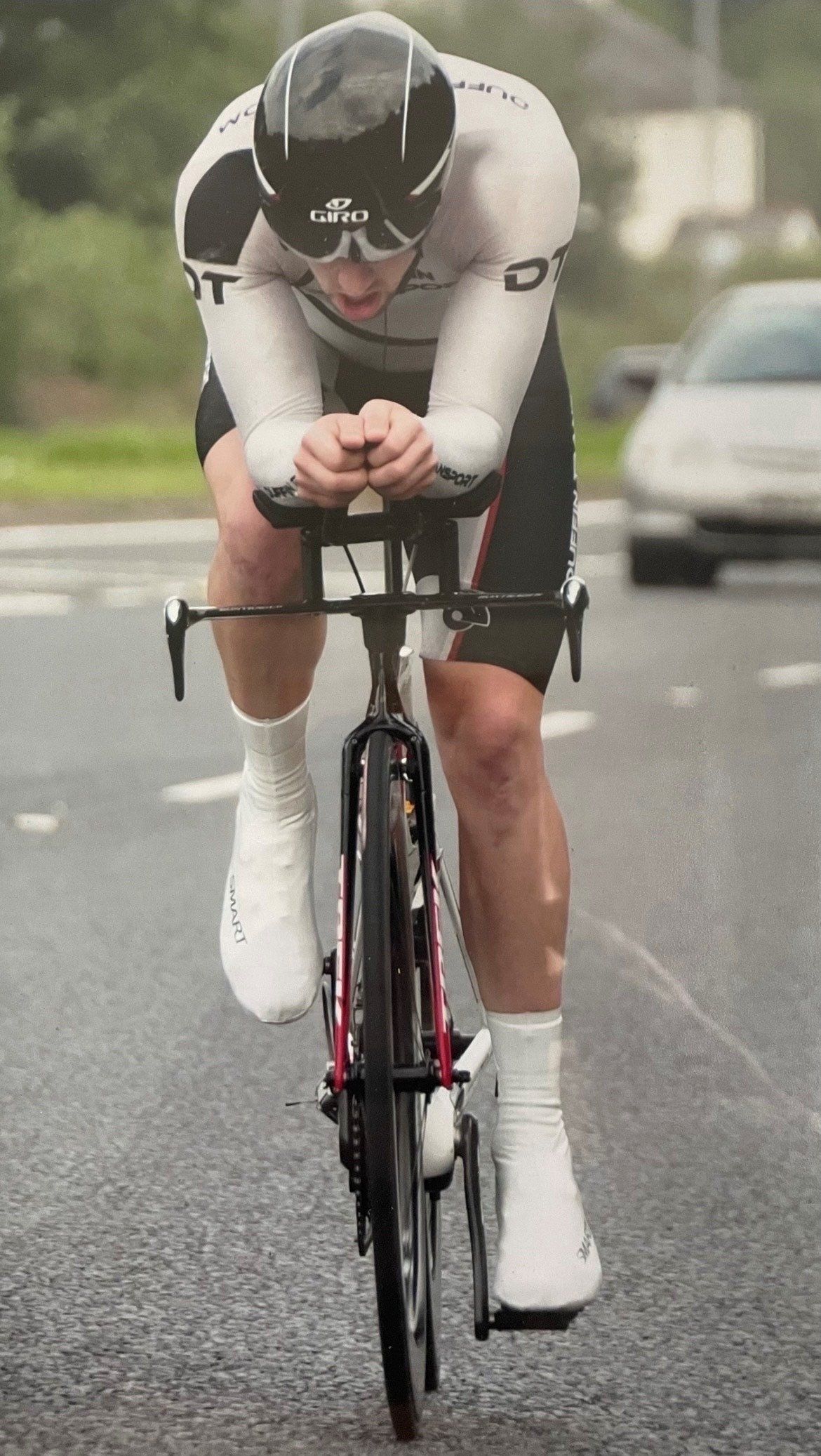 A man is riding a bike down a road.