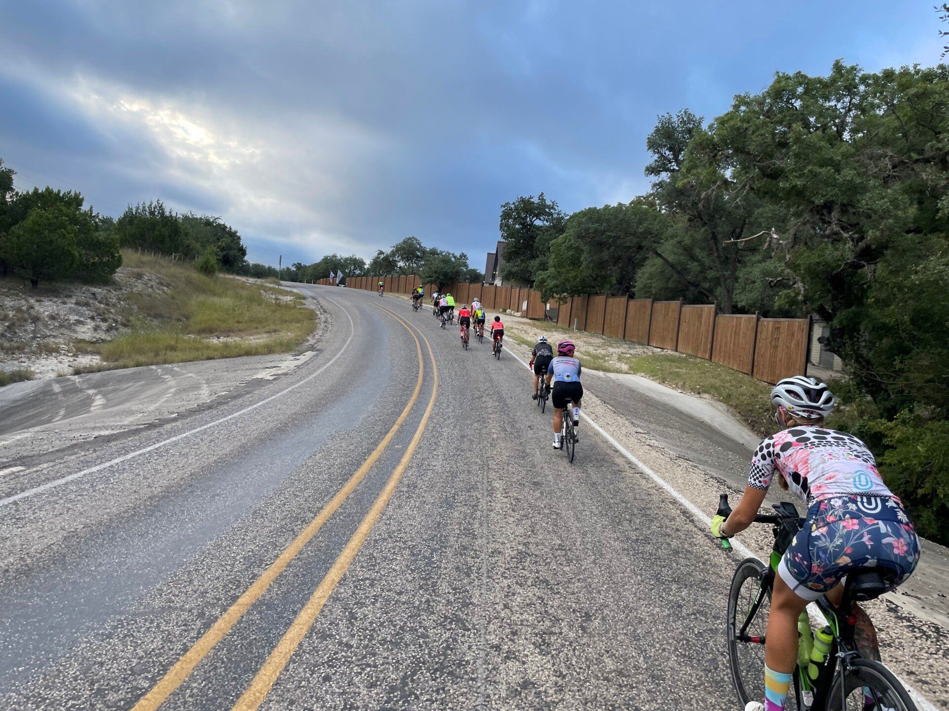 A group of people are riding bicycles down a road.