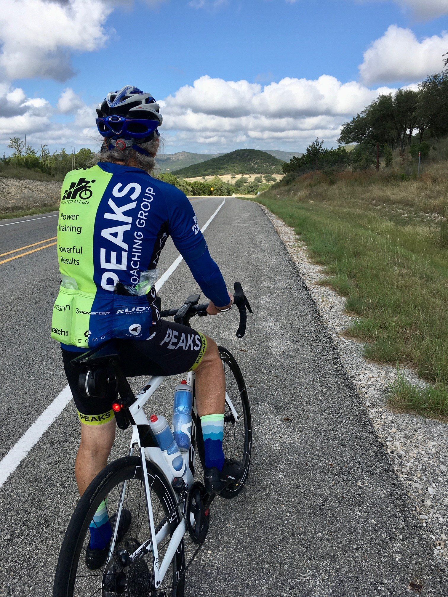 A man is riding a bike down a road.