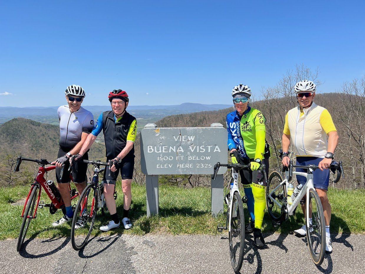 A group of people standing next to each other with bicycles.