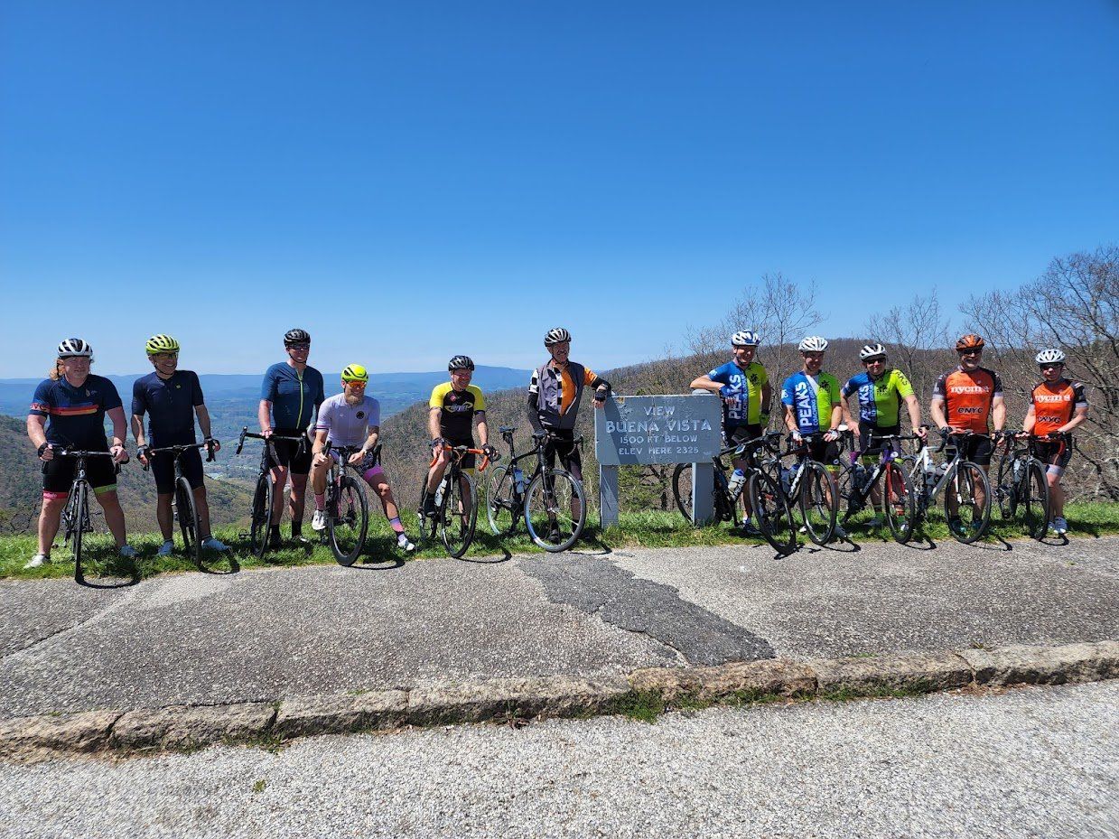 A group of people are standing next to each other on bicycles.
