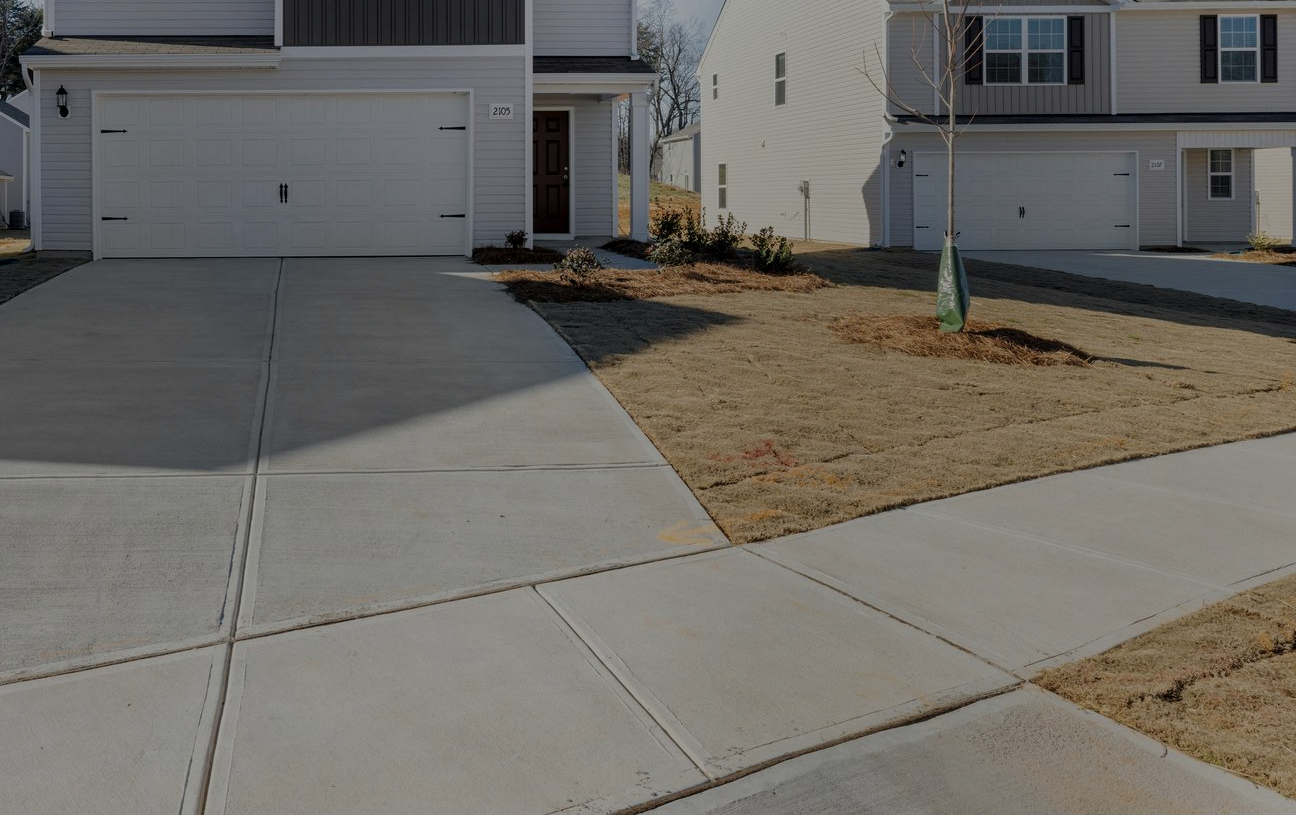 Concrete driveway contractors smoothing freshly poured concrete surface