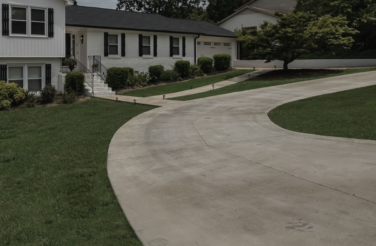 Homeowner reviewing driveway replacement progress with local concrete contractor