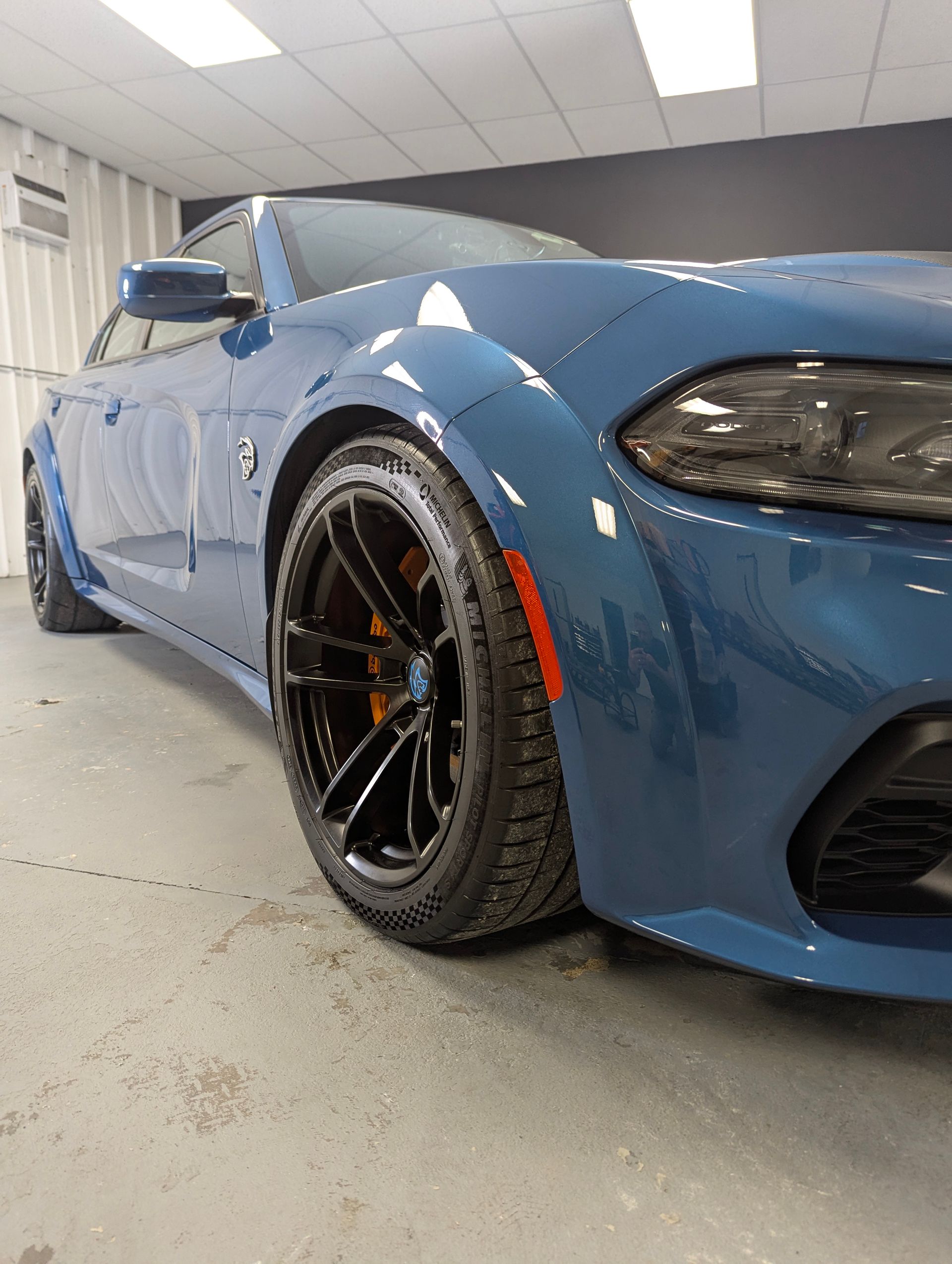 Blue Dodge Charger car parked inside a building, low angle shot.