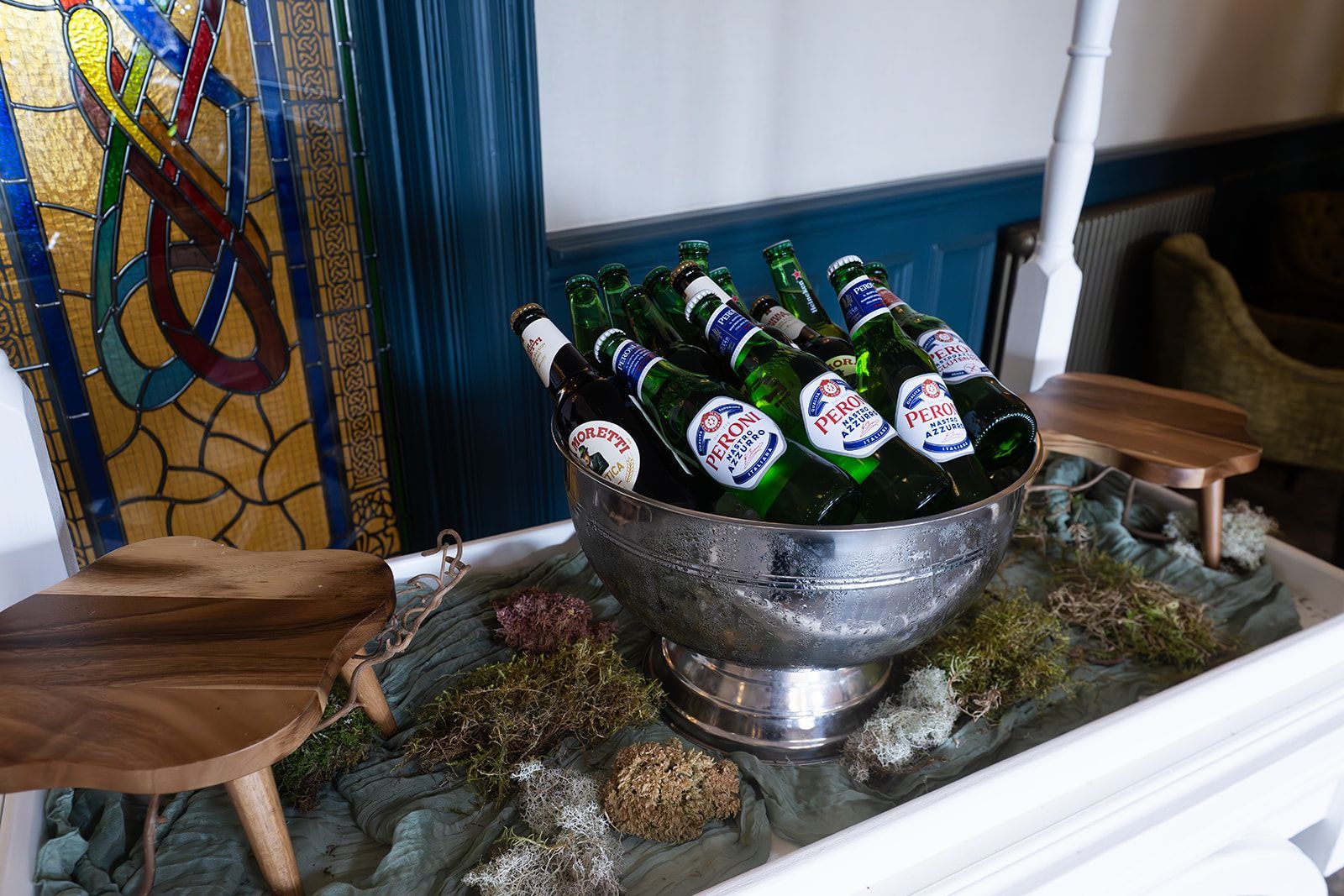 Bottles of beer chilling in an ice bucket on a decorative table display
