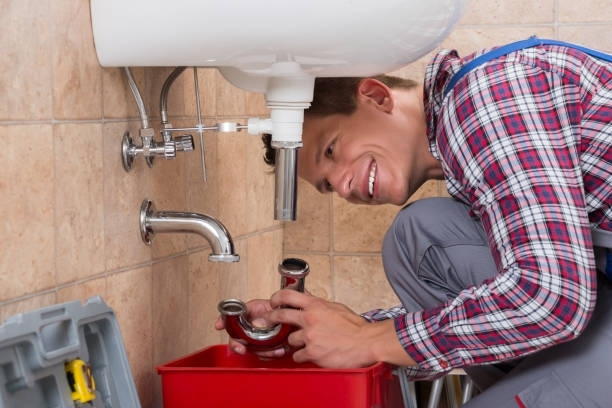 A person looking at a pipe | Hunter Sewer Service | Drain Cleaning Services Pekin Il