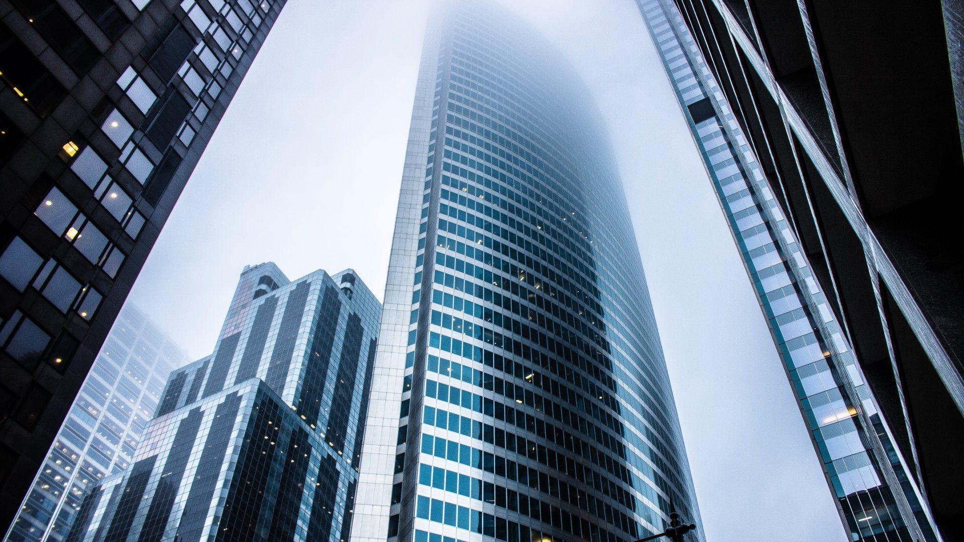 Looking up at a group of tall buildings in a city.