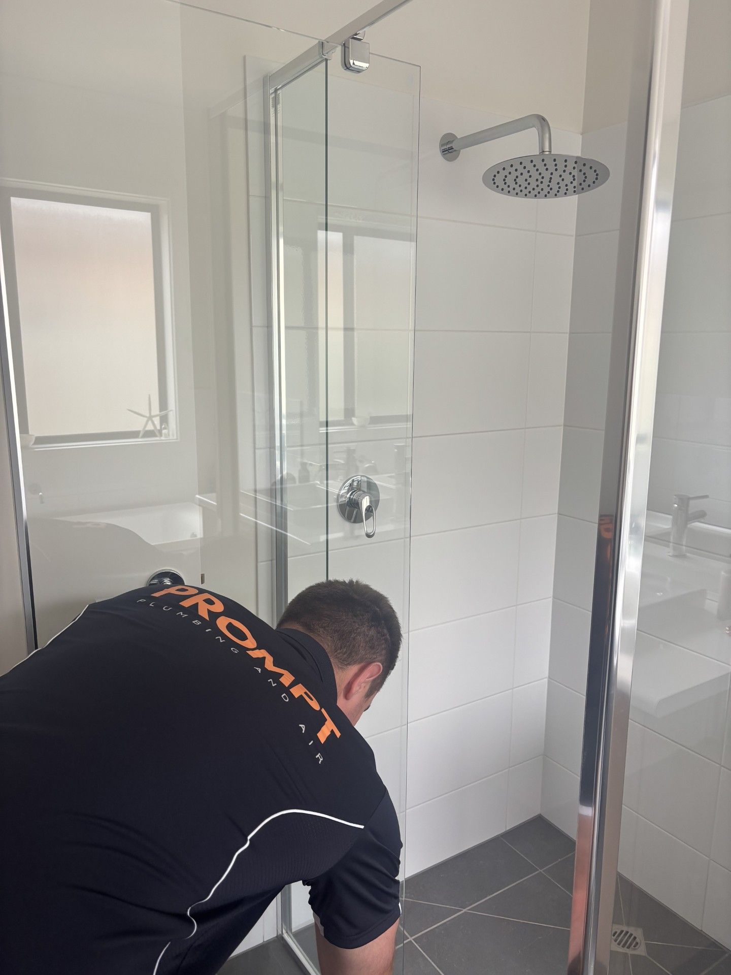 Plumber using acoustic equipment to locate concealed pipe leak in Adelaide