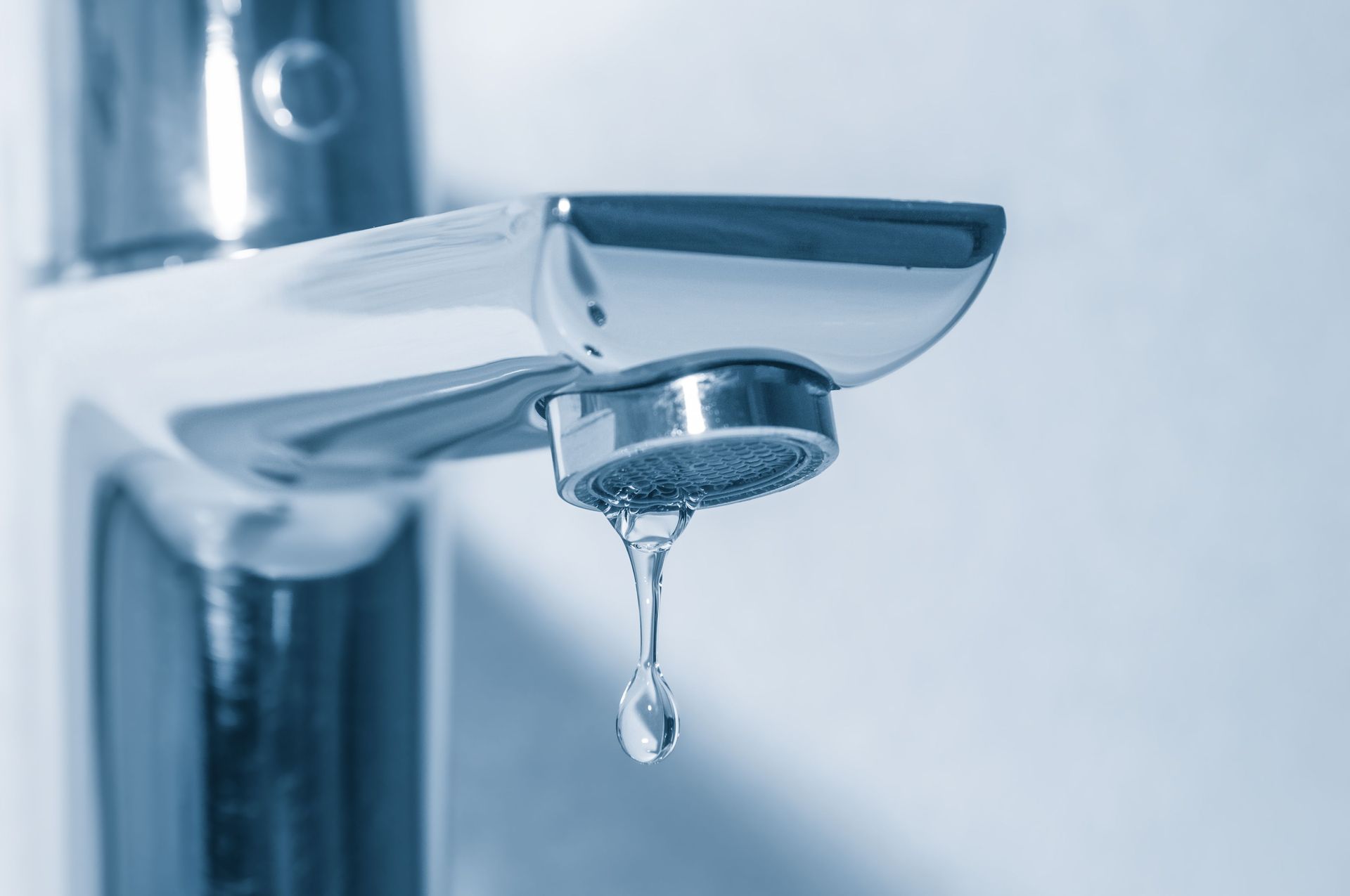 Plumber repairing a leaking kitchen tap in Adelaide at Prompt Plumbing and Air