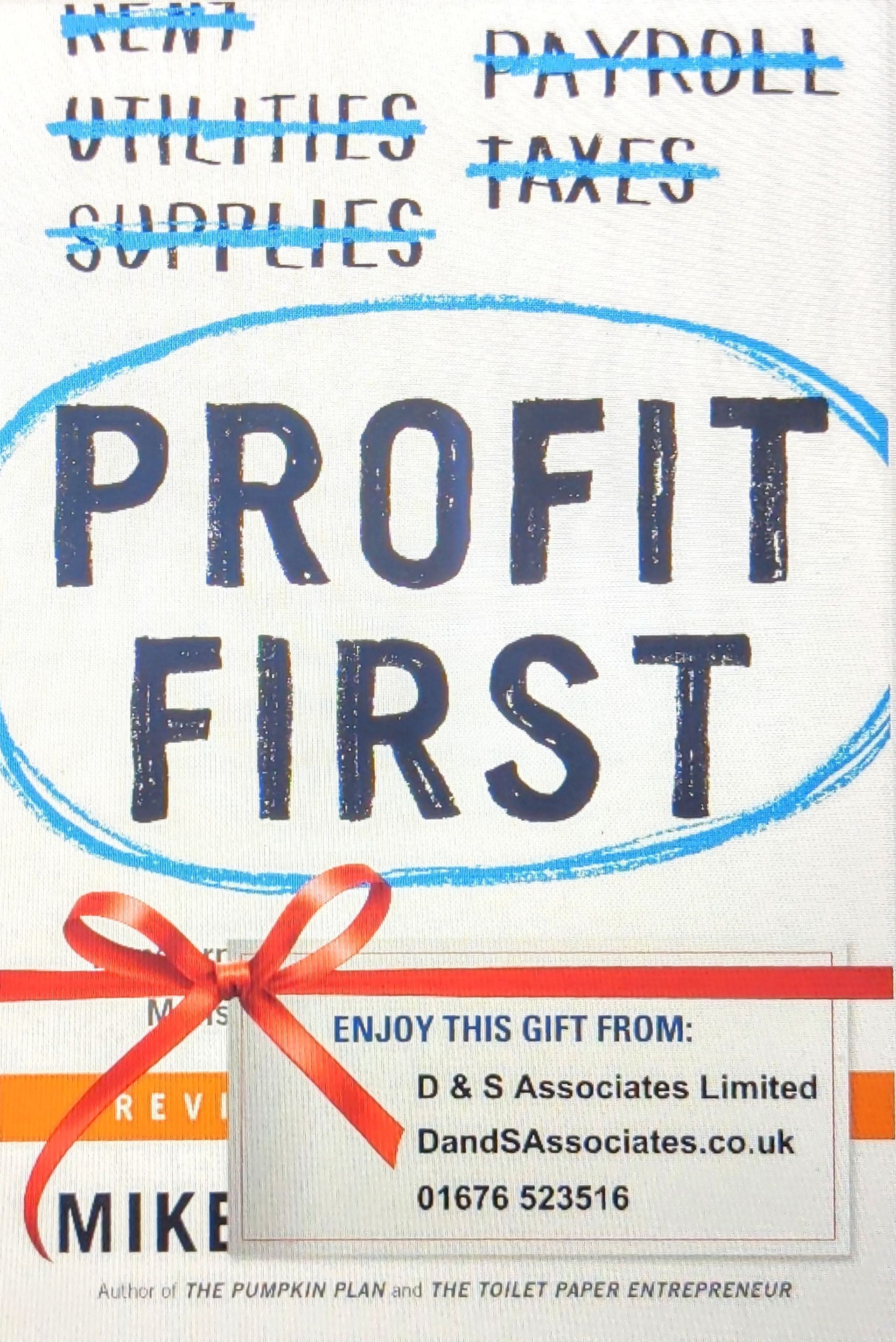 A sign that says profit first with a red bow