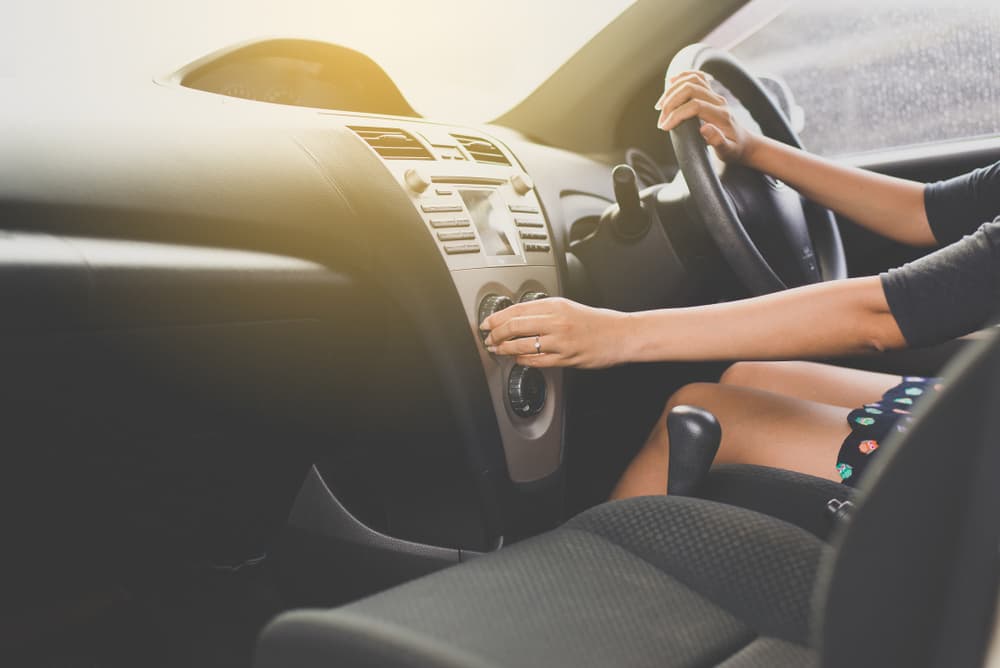 Woman Driving A Car while Turning On Car Air Condition - Auto Mechanics In Aitkenvale, QLD